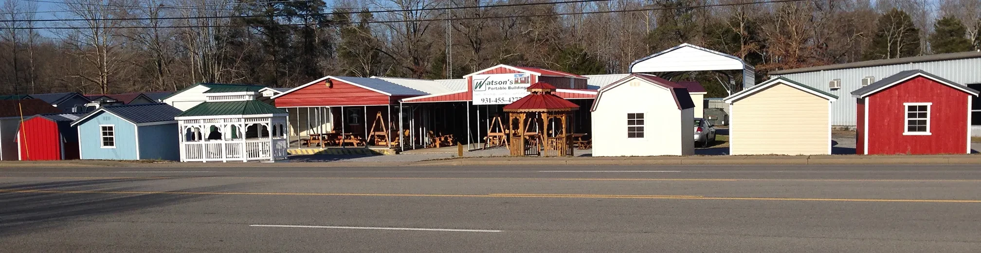 row of sheds, carports, and gazebos at the tullahoma lot as seen from the road