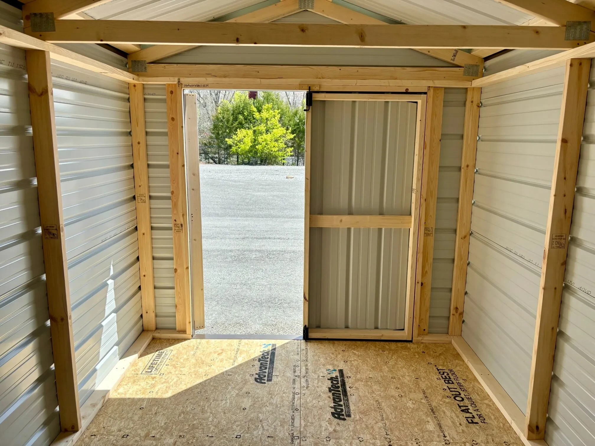 The inside of a metal shed showing the double doors open