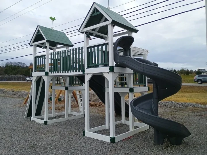 Huge playset combo with two towers and multiple slides and green accents