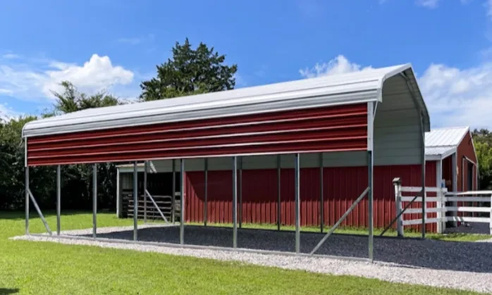A tall and long RV cover with a white roof and red side panels