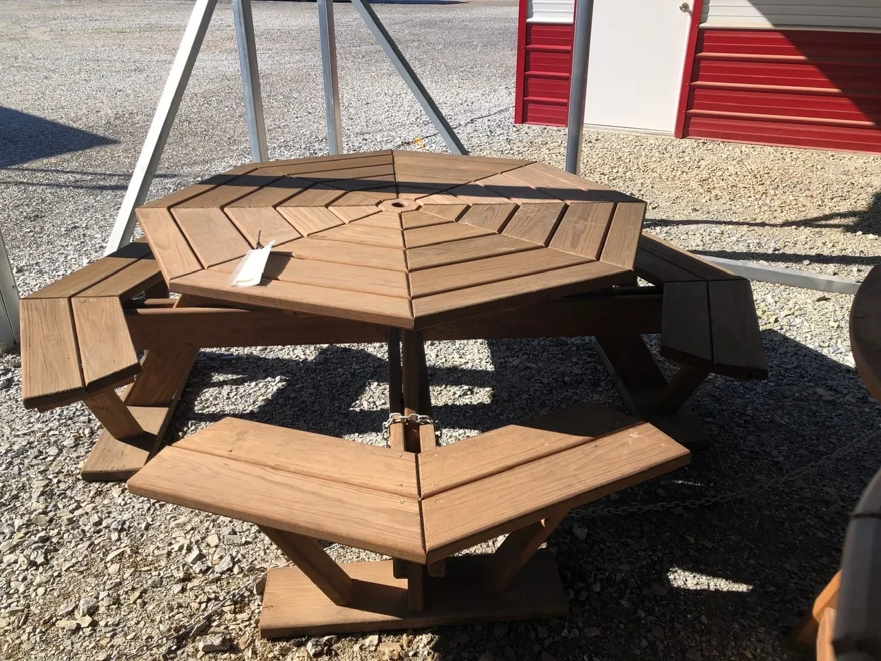 a wood stained table that is built in a manner which resembles and octagon shape