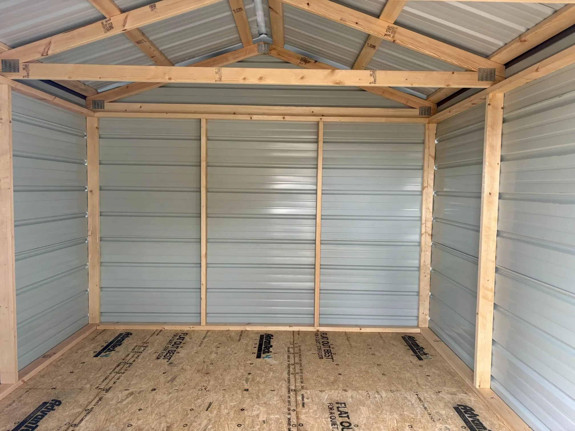 The inside of a metal shed, showing the framework