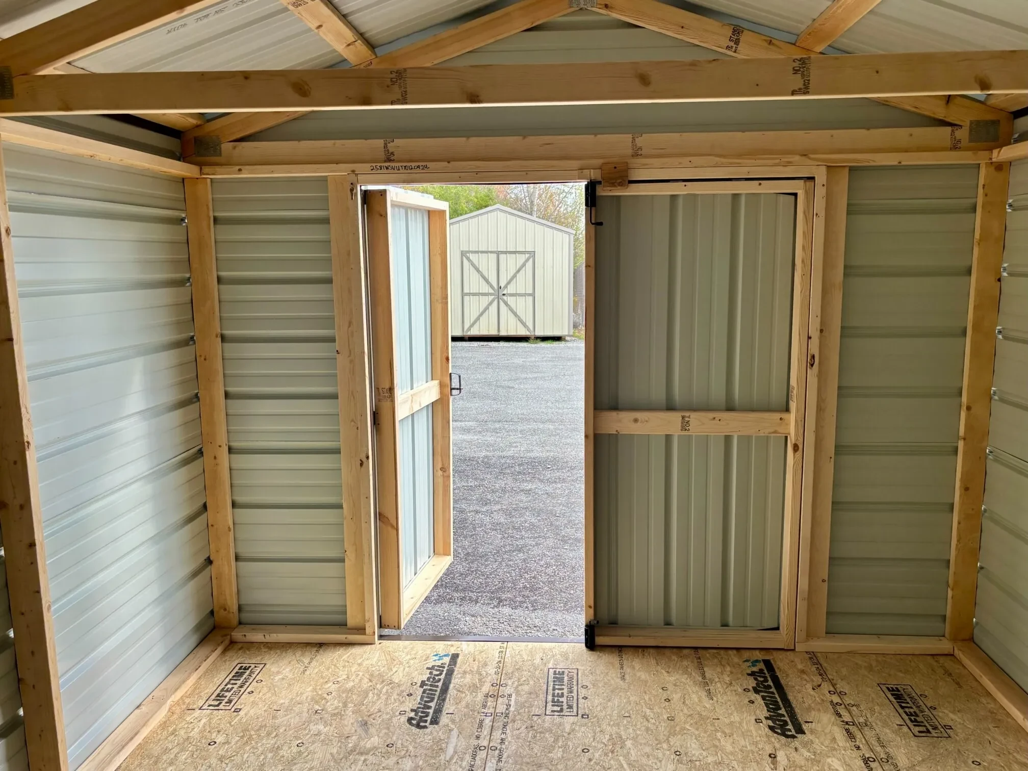 The inside of a metal shed, showing the double doors open