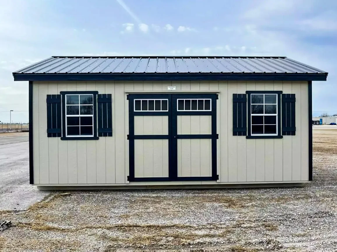 a white shed with black roof and trim and multiple windows with shutters