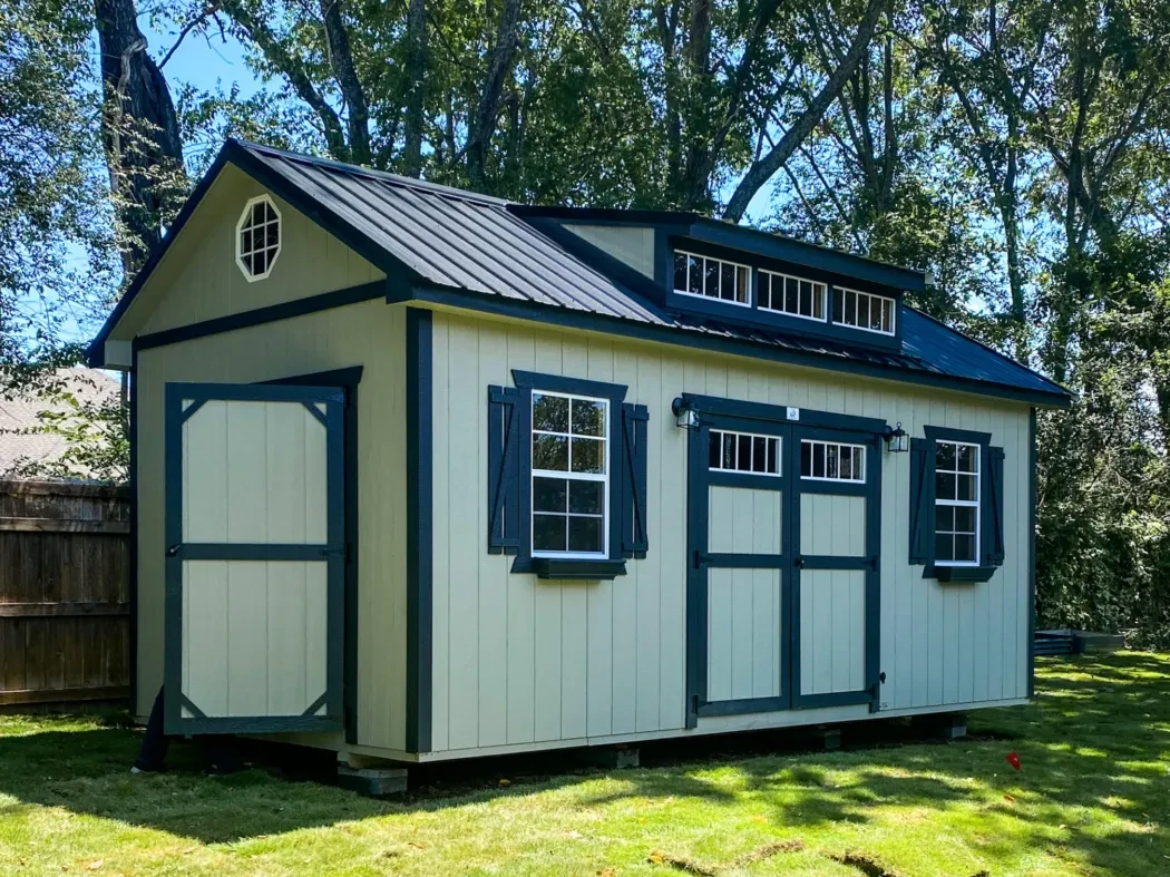 An elaborate wood shed with many windows and accenting trim and shutters