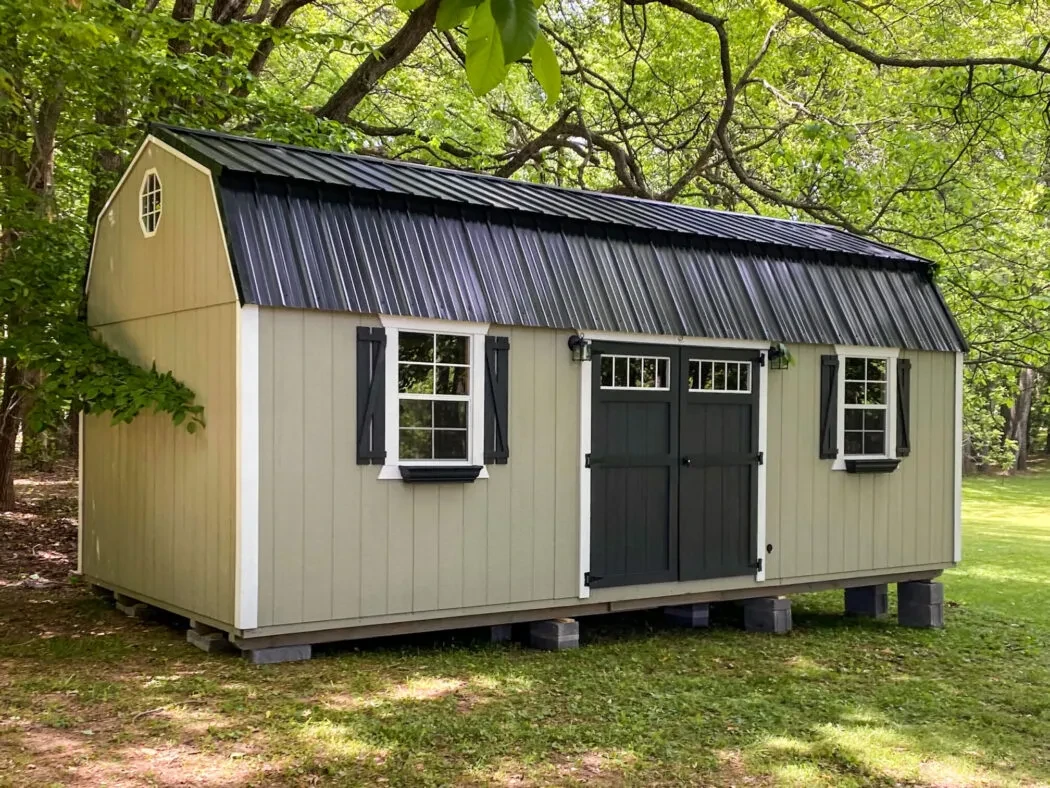 A long lofted barn shed among trees