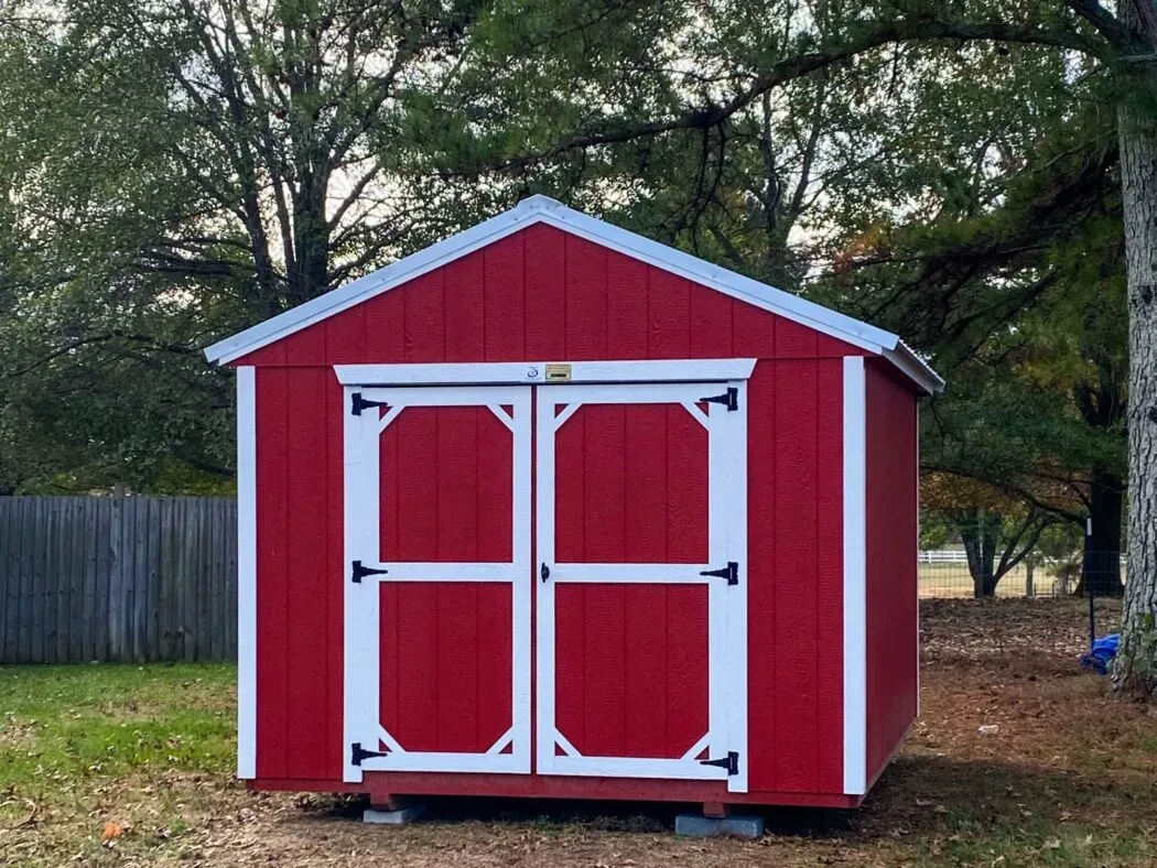 a small red and white backyard shed