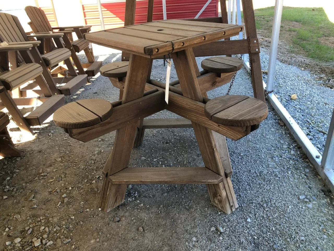 a wood stained square table with four pedestals holding circular seats to sit down on
