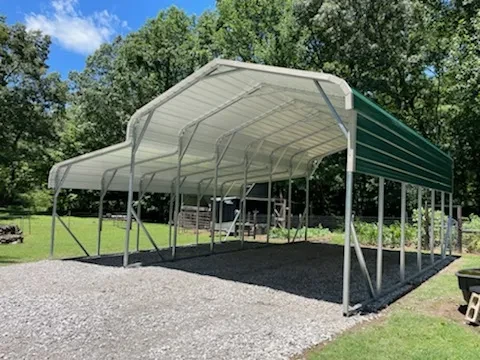 A large green rounded frame carport with a rounded frame lean-to on one side