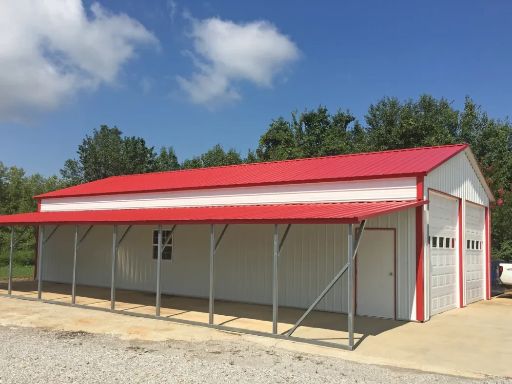 A large red and white garage with a drop-down lean-to on the one side