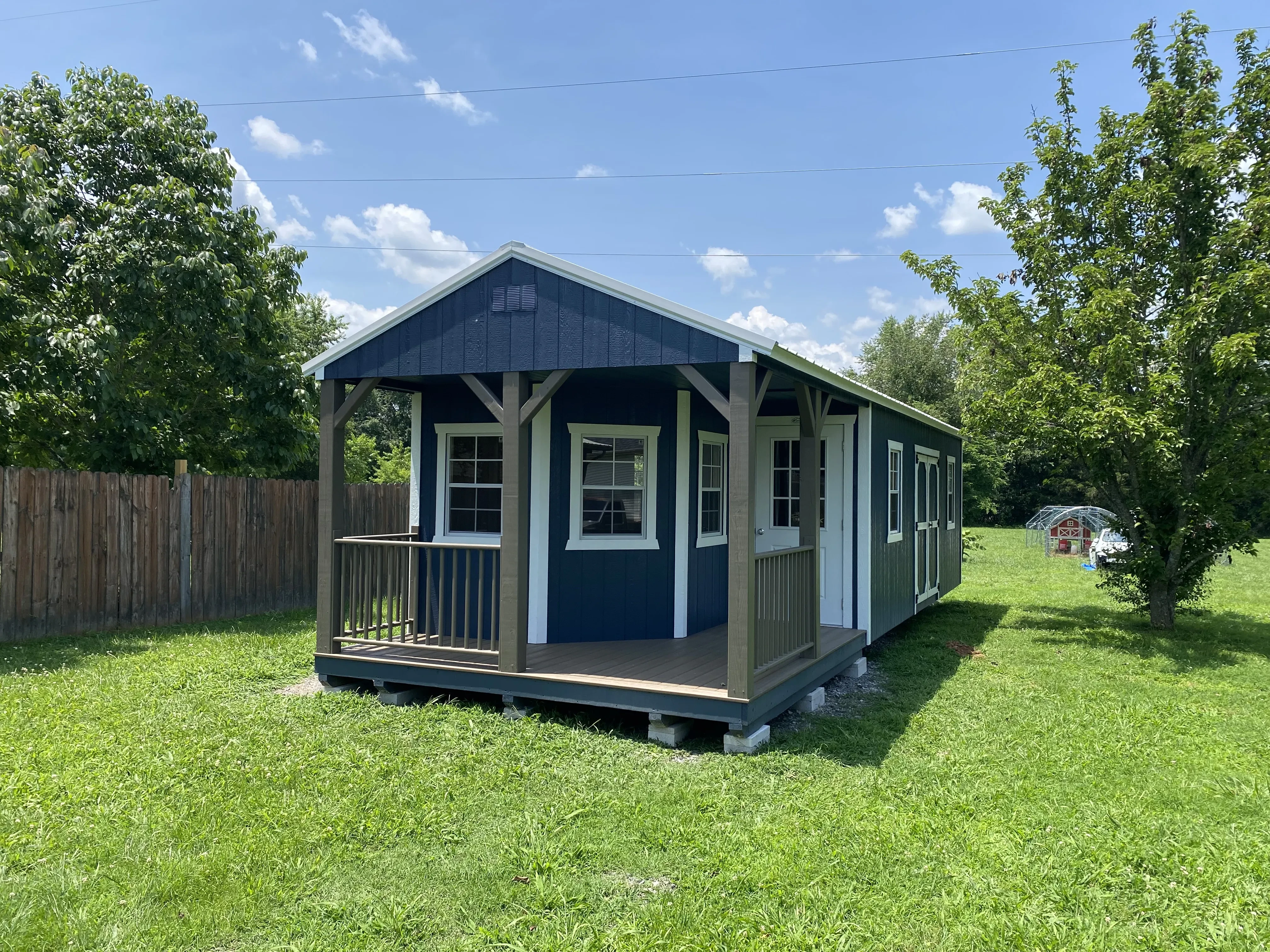 Deluxe cabin with wraparound porch and blue and white color scheme