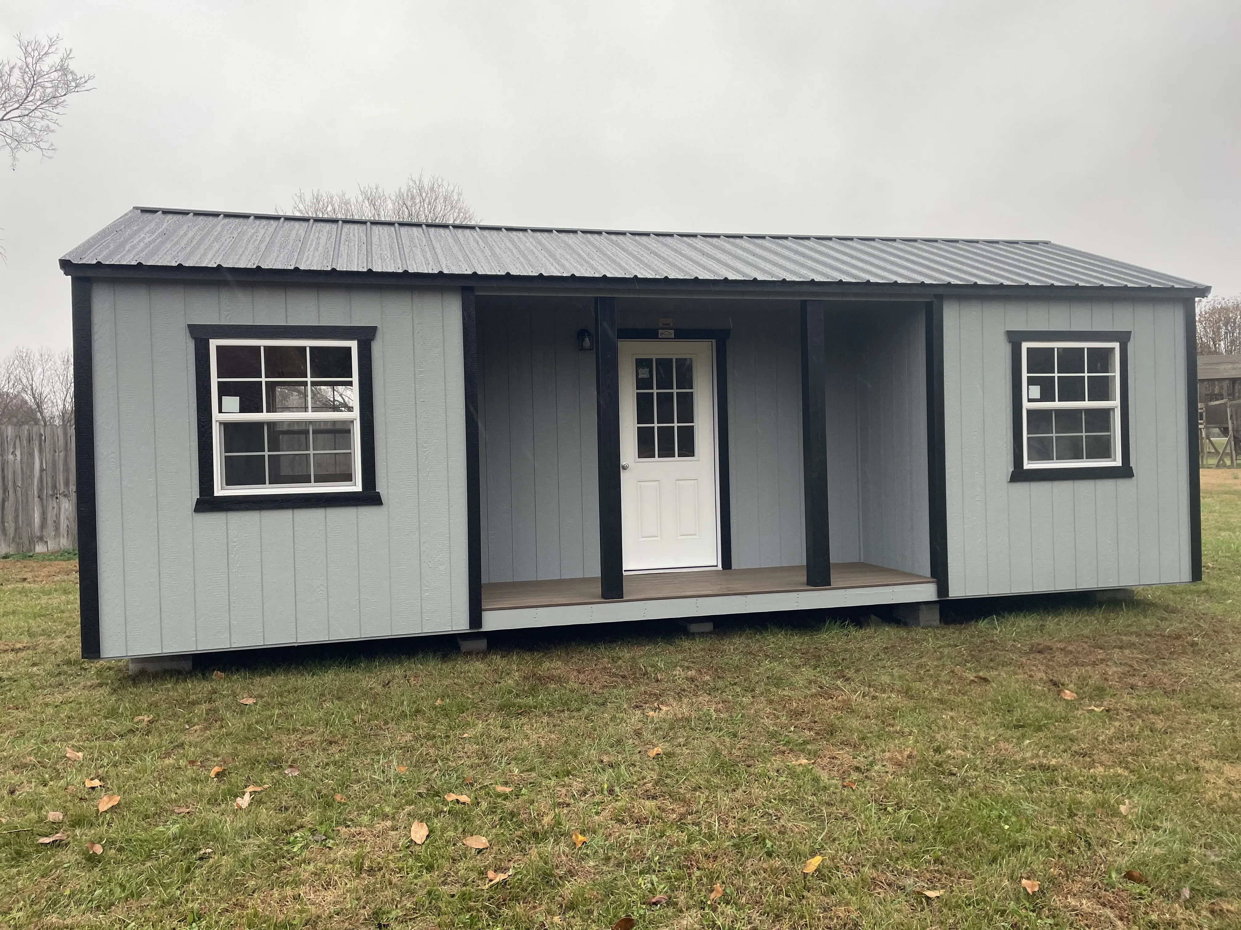 Gray and black cabin with inset side porch