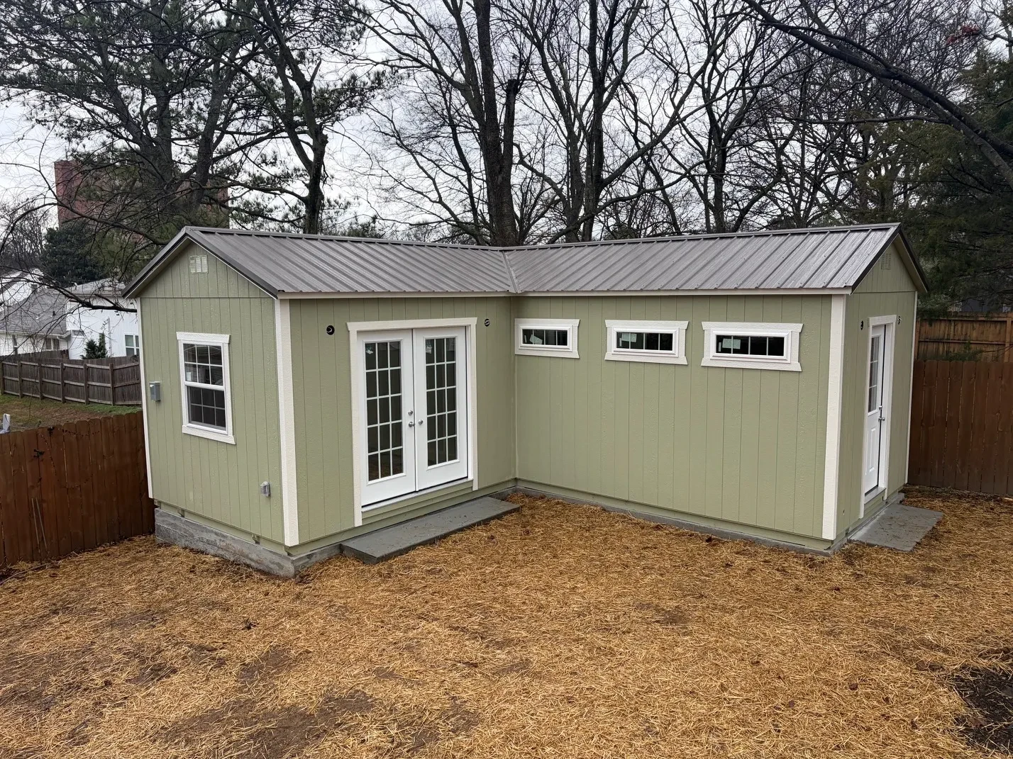 special L-shape shed with patio doors and transom windows