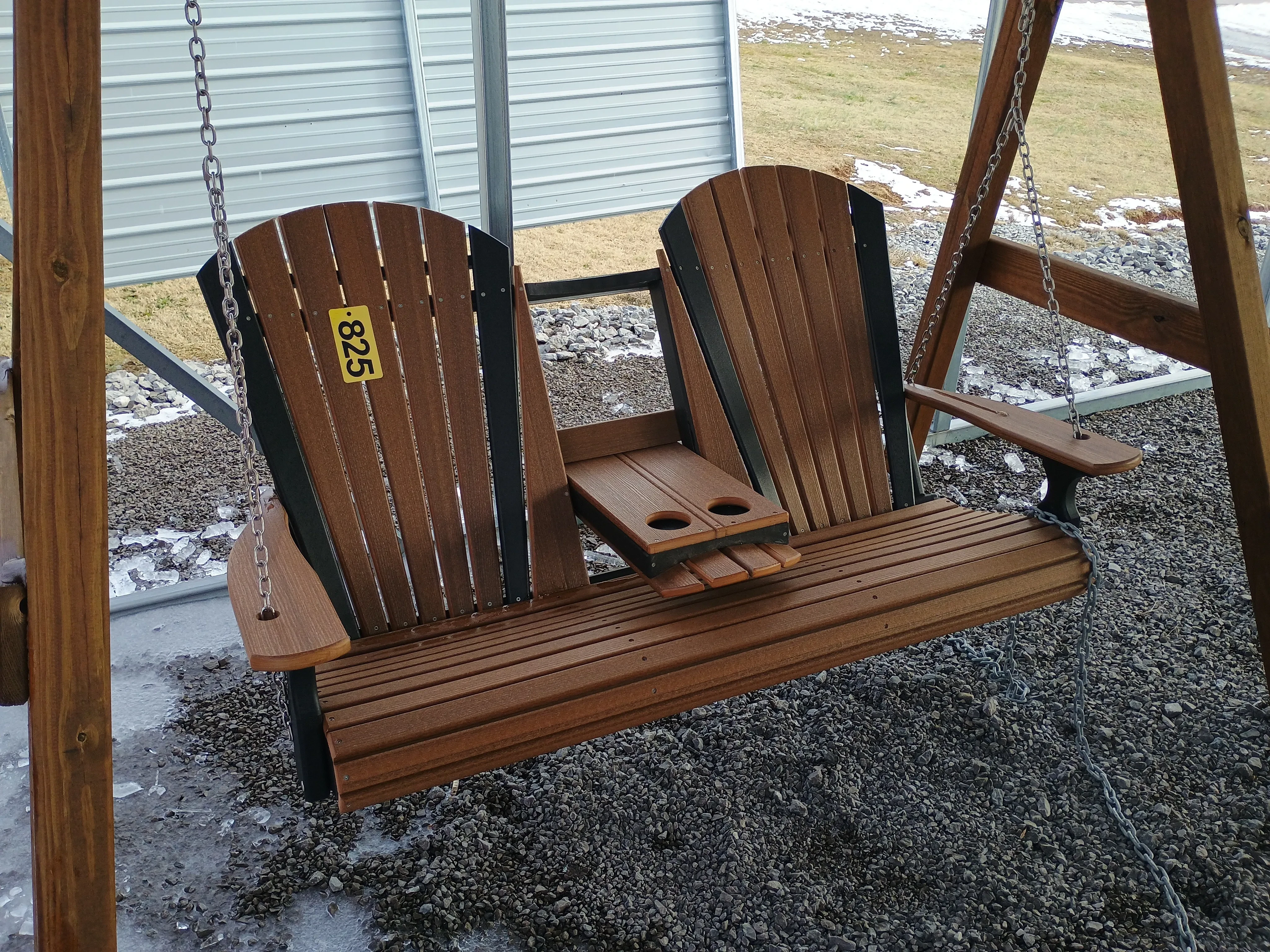 a polywood seat with a flip down center console. it is a brown color with black accents