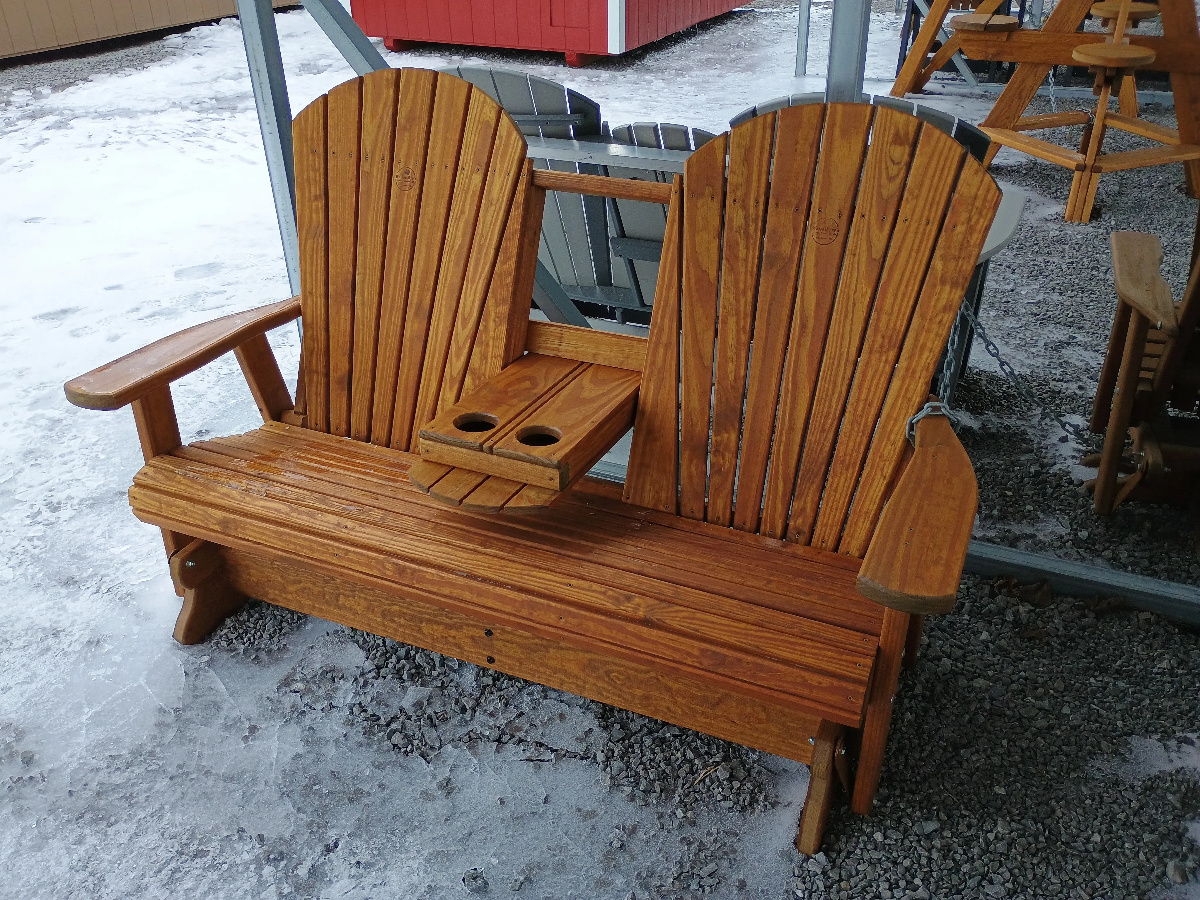 a wood stained bench that has a center console flipped in the down position