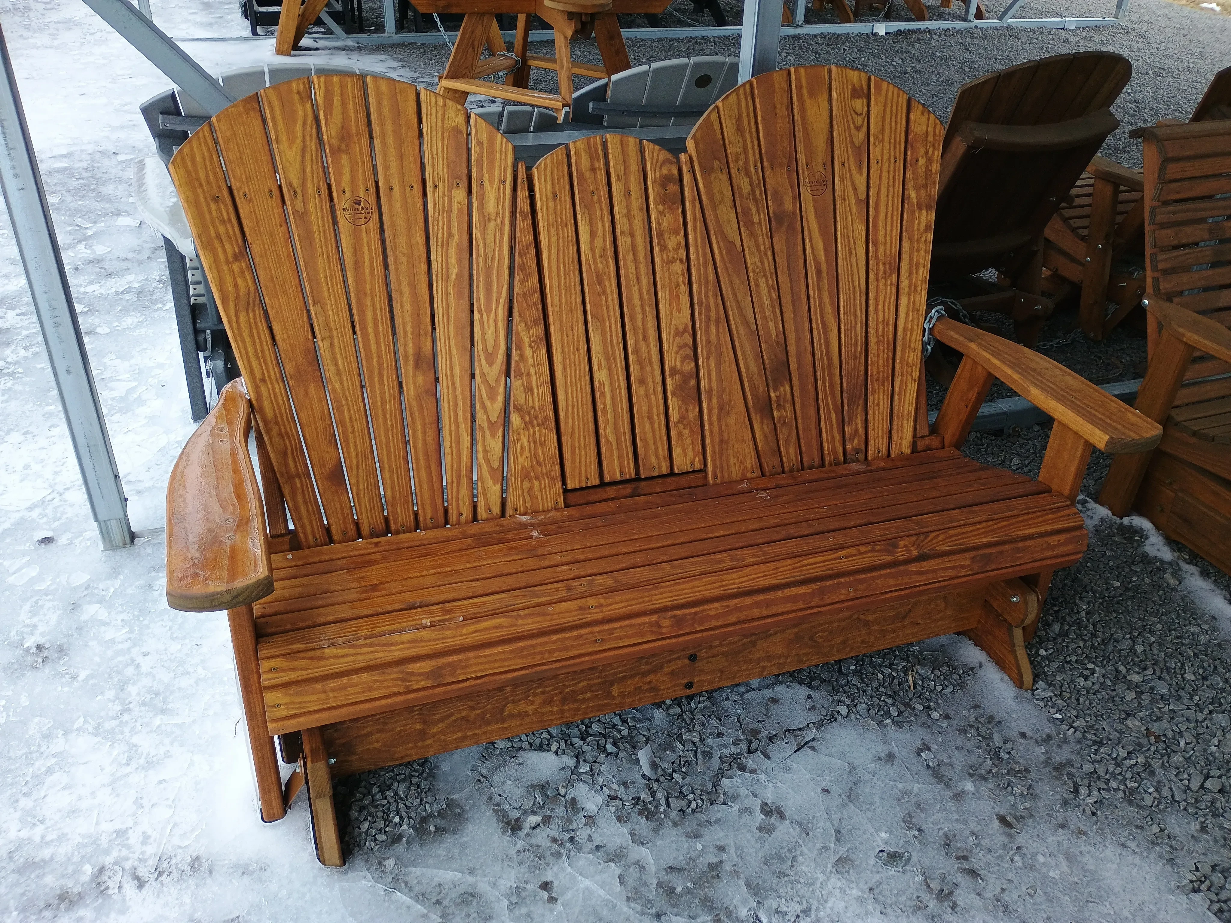 a wood stained bench with a center console in the up position