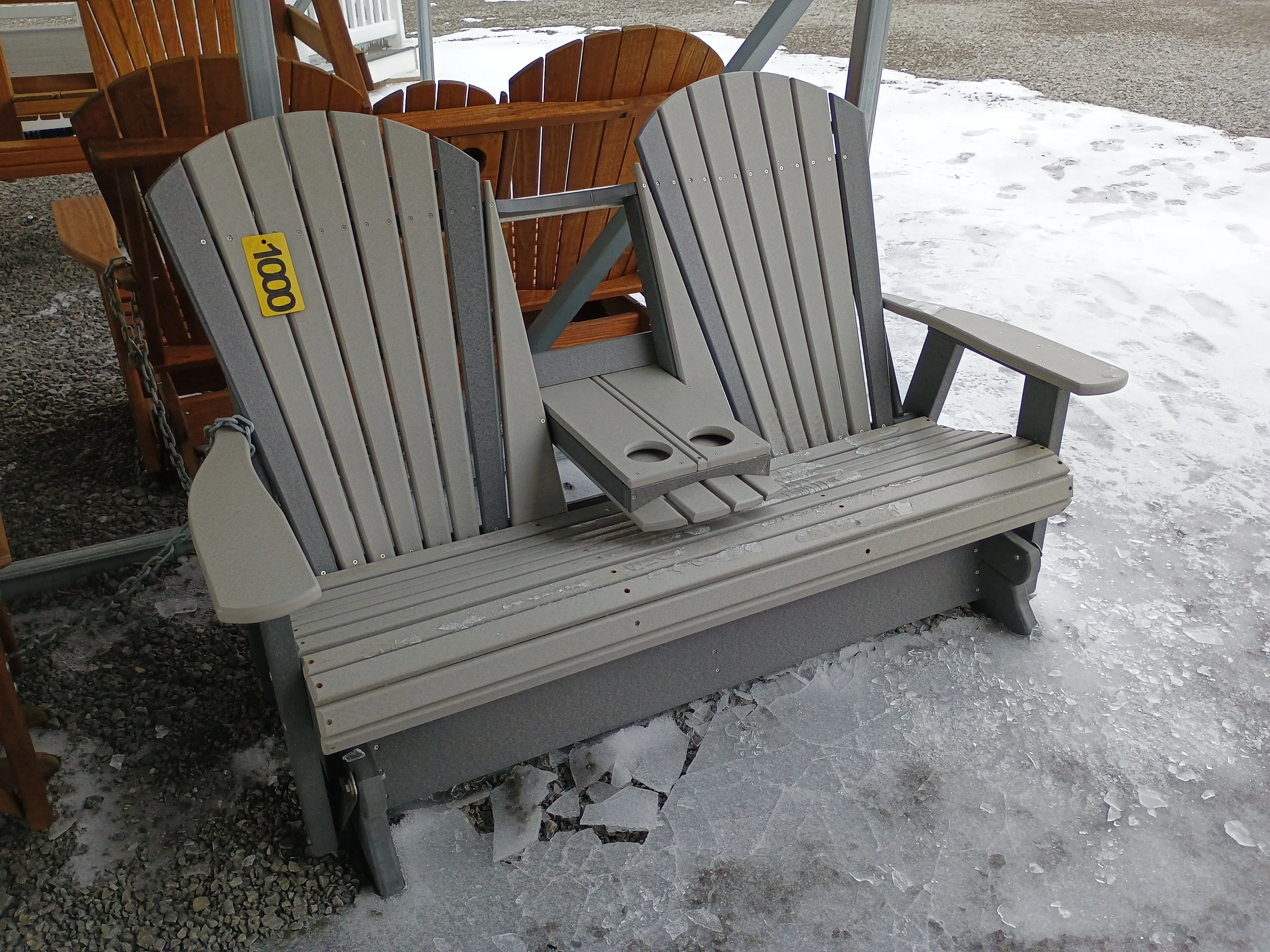 a polywood bench with a center console in the down position. There is ice all around the floor