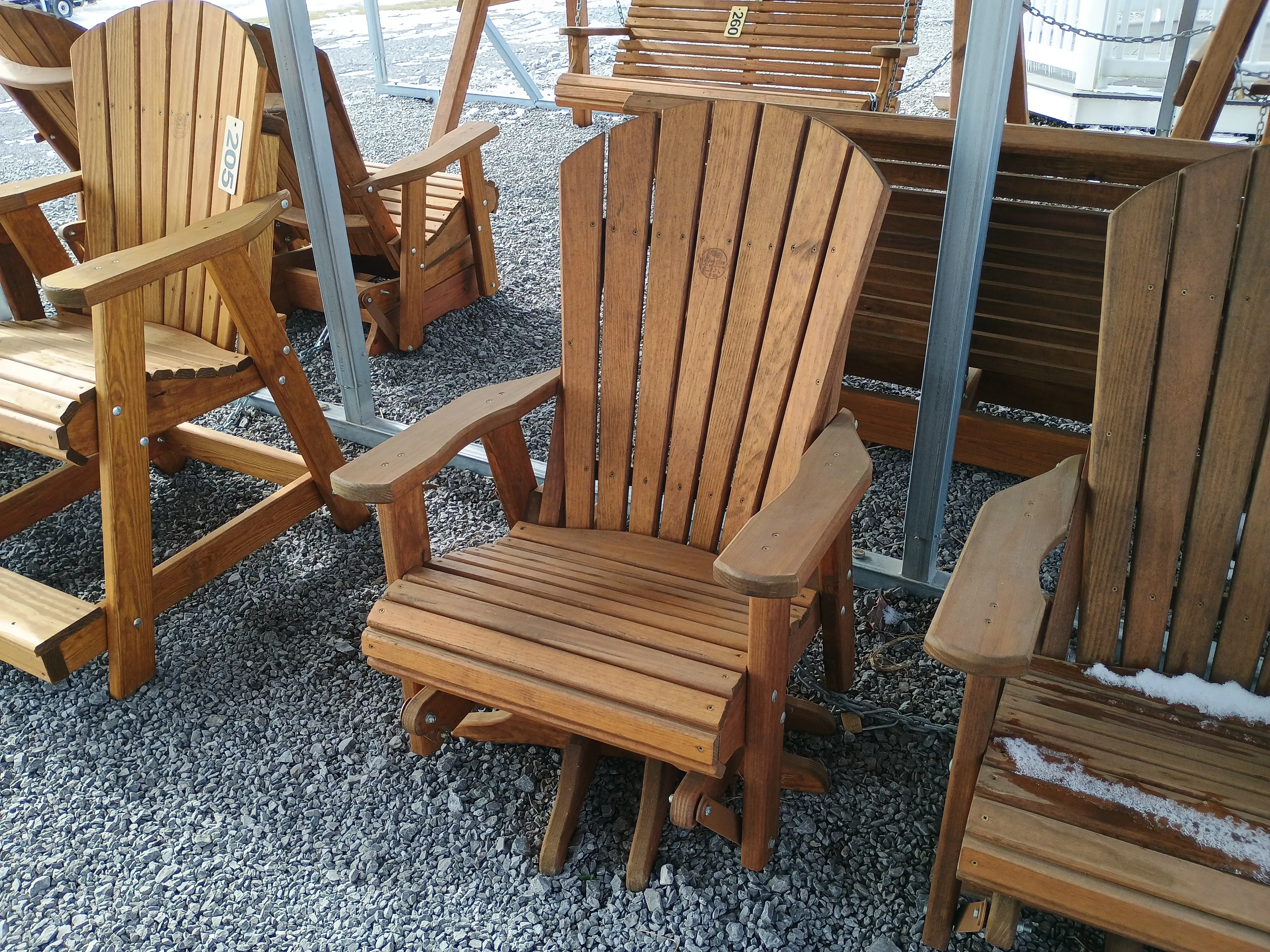 a stained wood chair that can swivel and glide. It also has arm rests