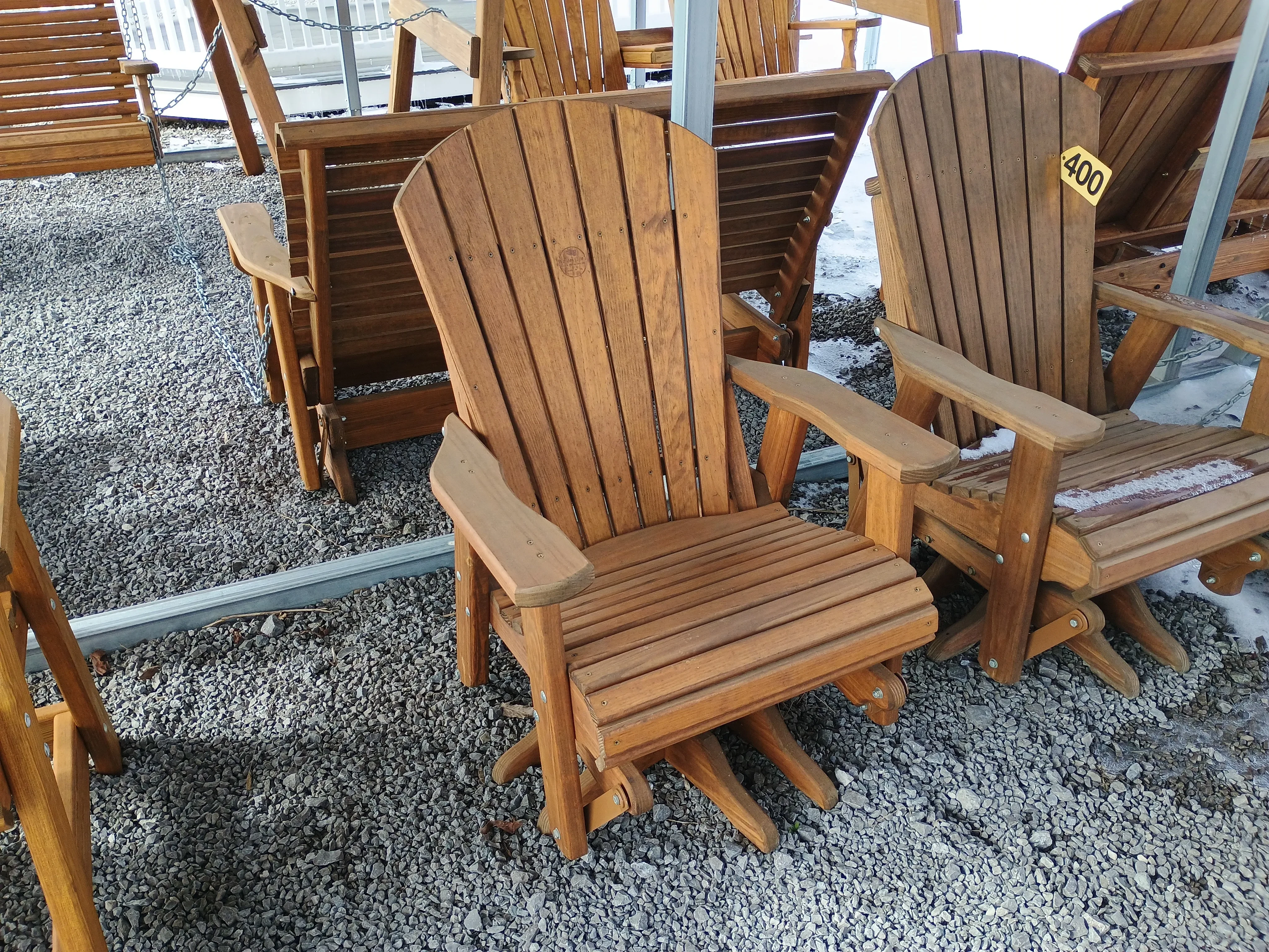 a stained wood chair with arm rests. It can sivel and glide due to the hardware it was built with