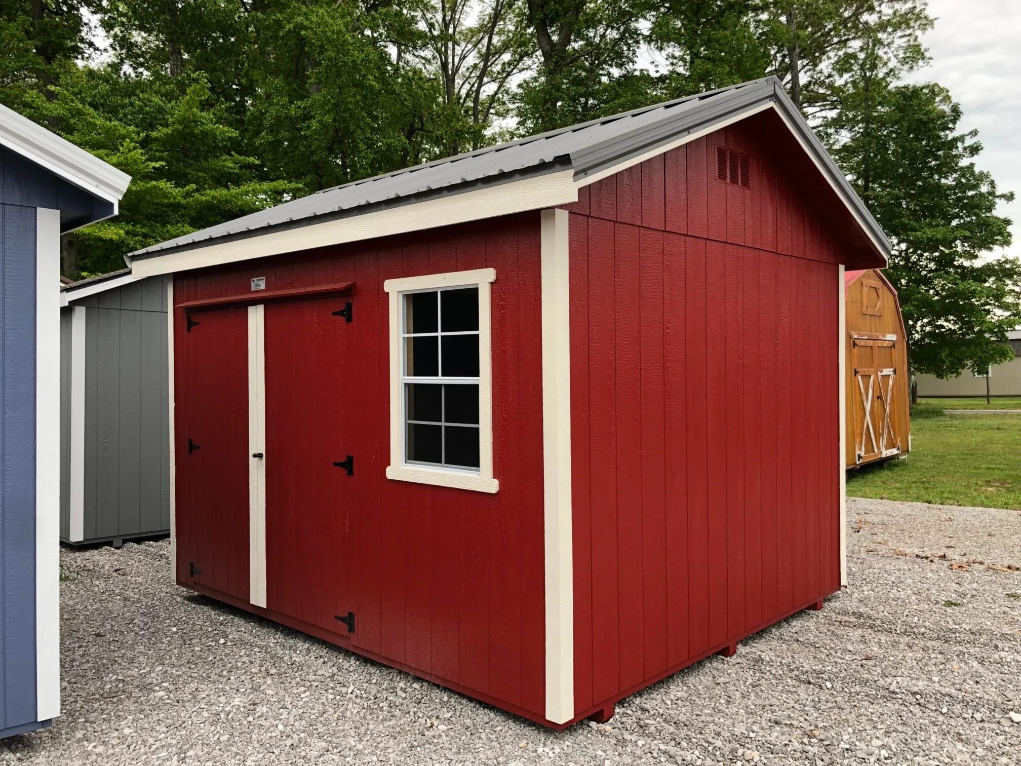 A red shed with double doors and a window