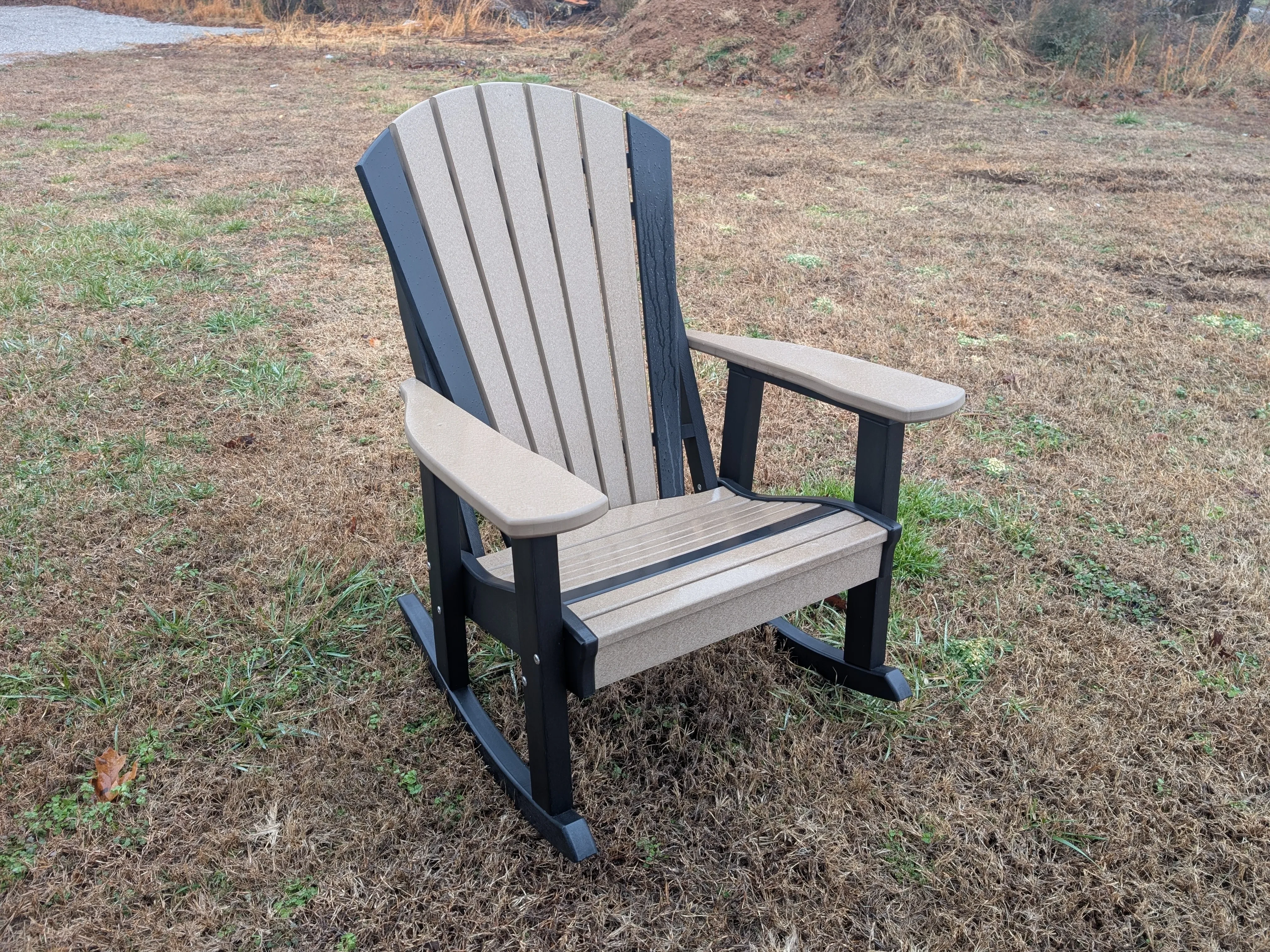 a weathered wood rocking chair. It has black rocker legs and accents.