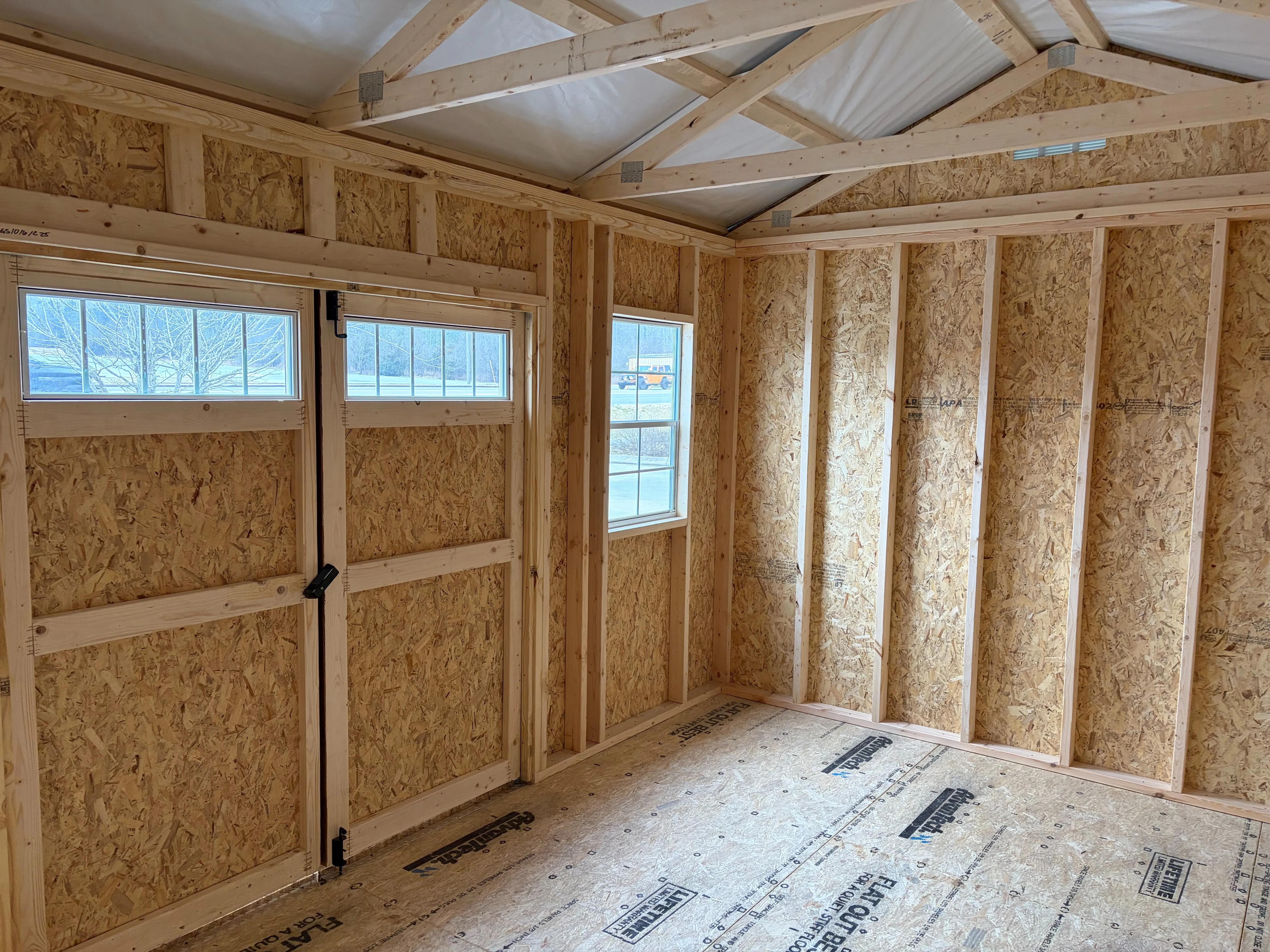interior of the 10x16 wood walls double doors & windows