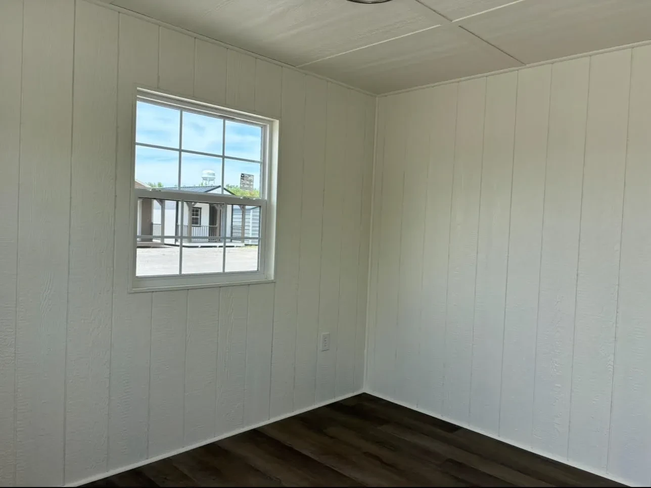 The inside of a finished out shed showing the panels and a window