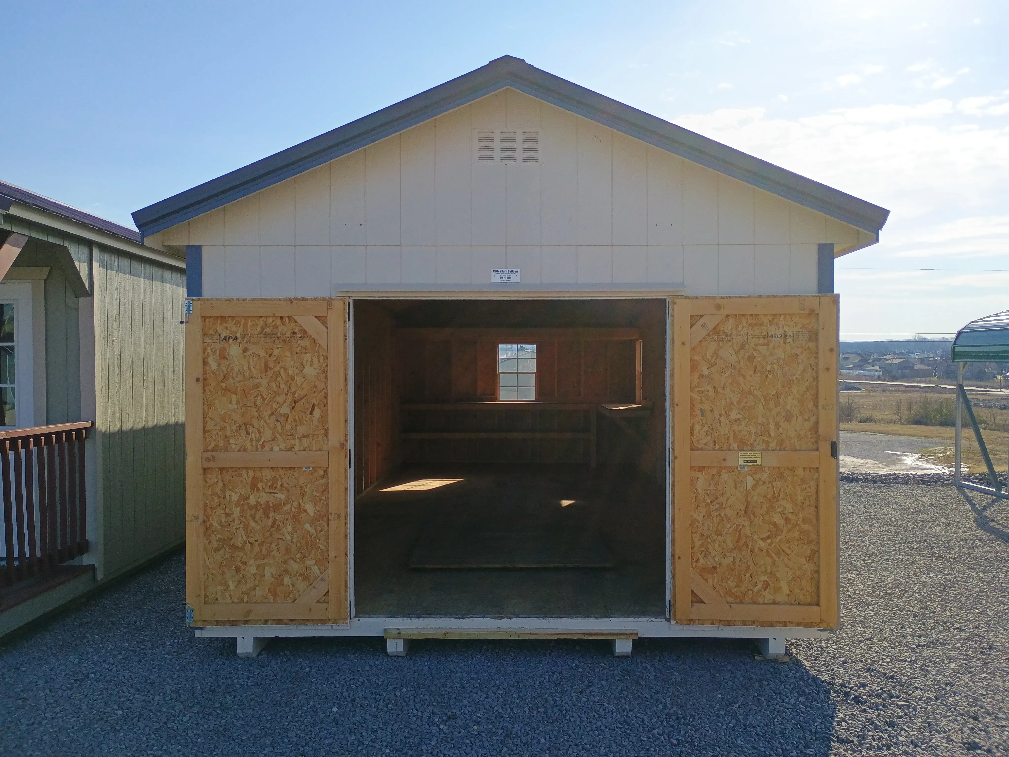 exterior front of 12x28 premium wood utility REPO shed, showing open double doors