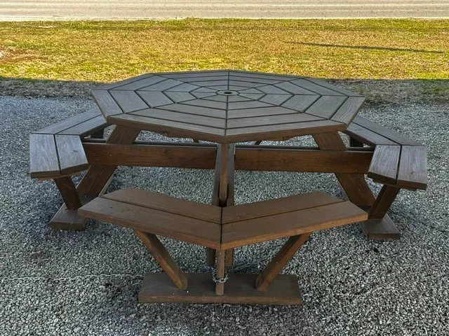 a wood stained and sealed table built in the shape of an octagon