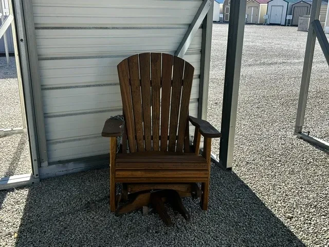 a wood chair sitting on gravel. It can swivel and glide