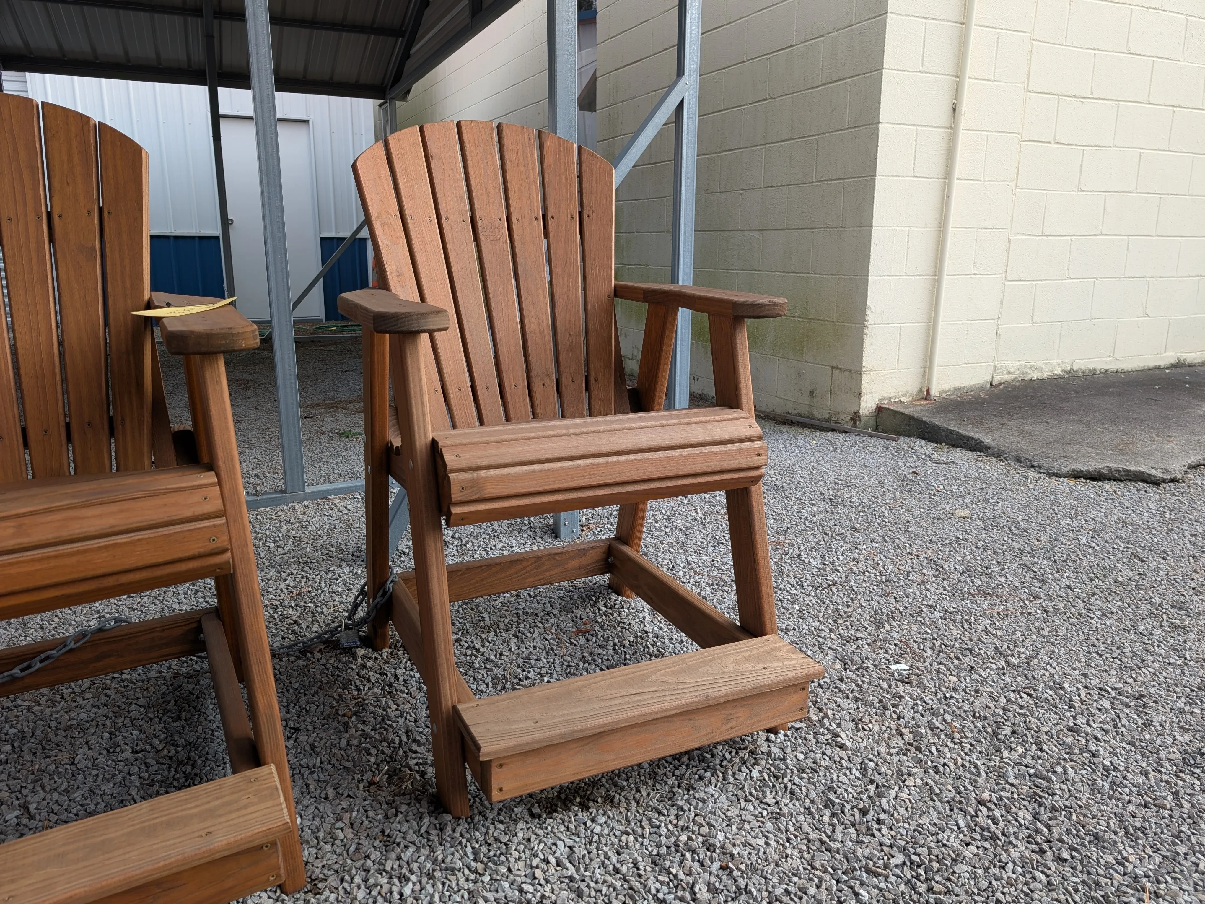 a wood chair with armrests. It also has footrests