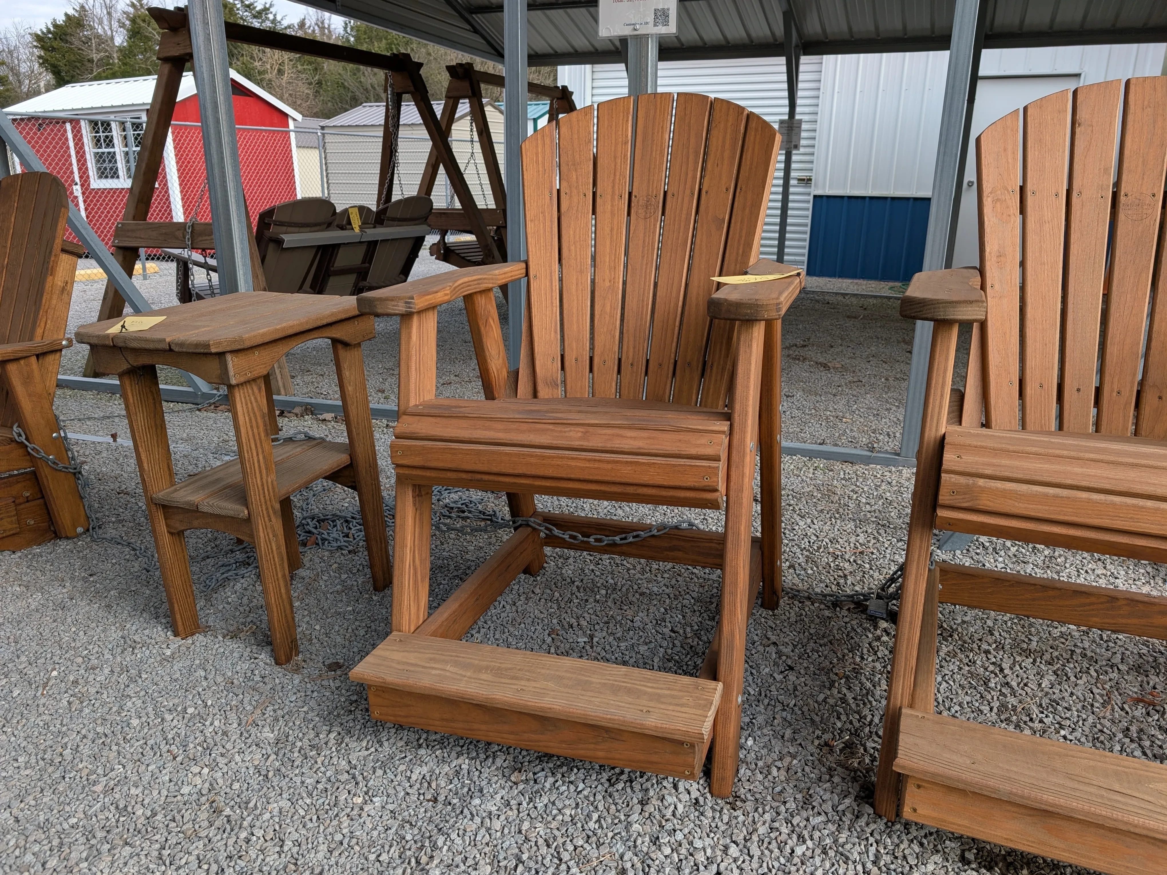 a wood chair sitting in the gravel. You can see other furniture nearby
