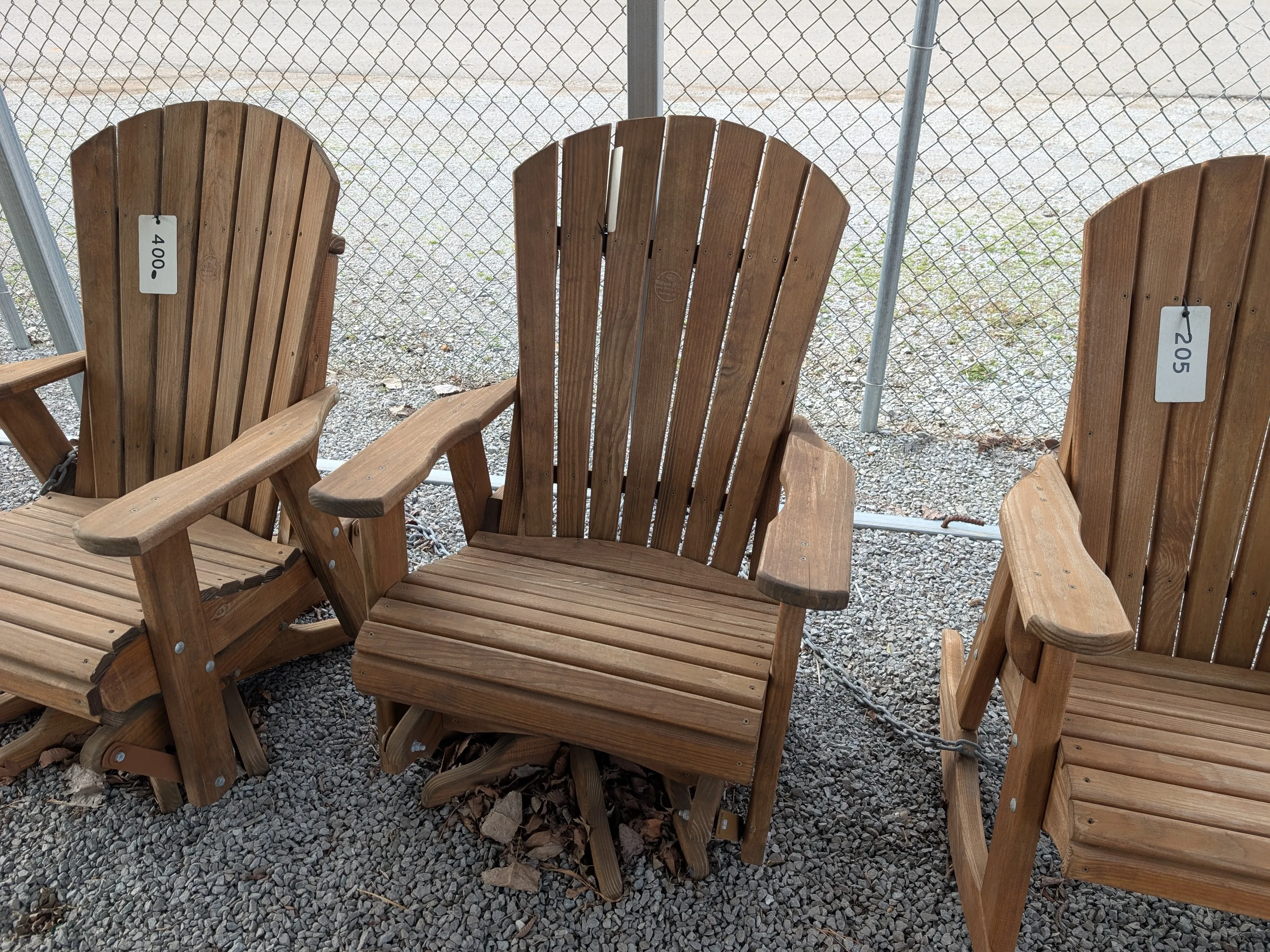 a stained and sealed wood chair with armrests that can swivel 360° and glides back and forth