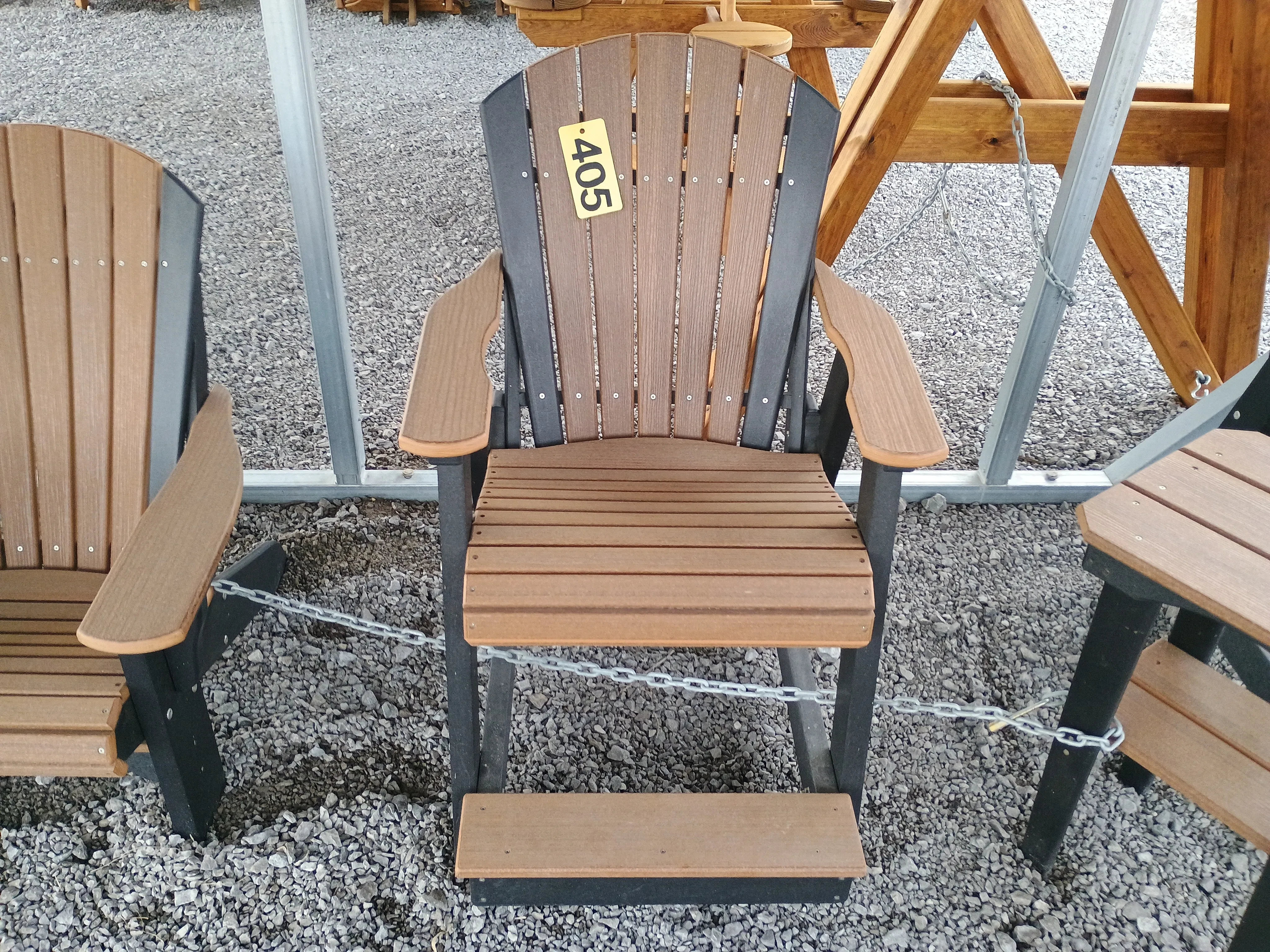 a brown chair with black accents chained up to other furniture nearby. It has a yellow price tag that shows "405"