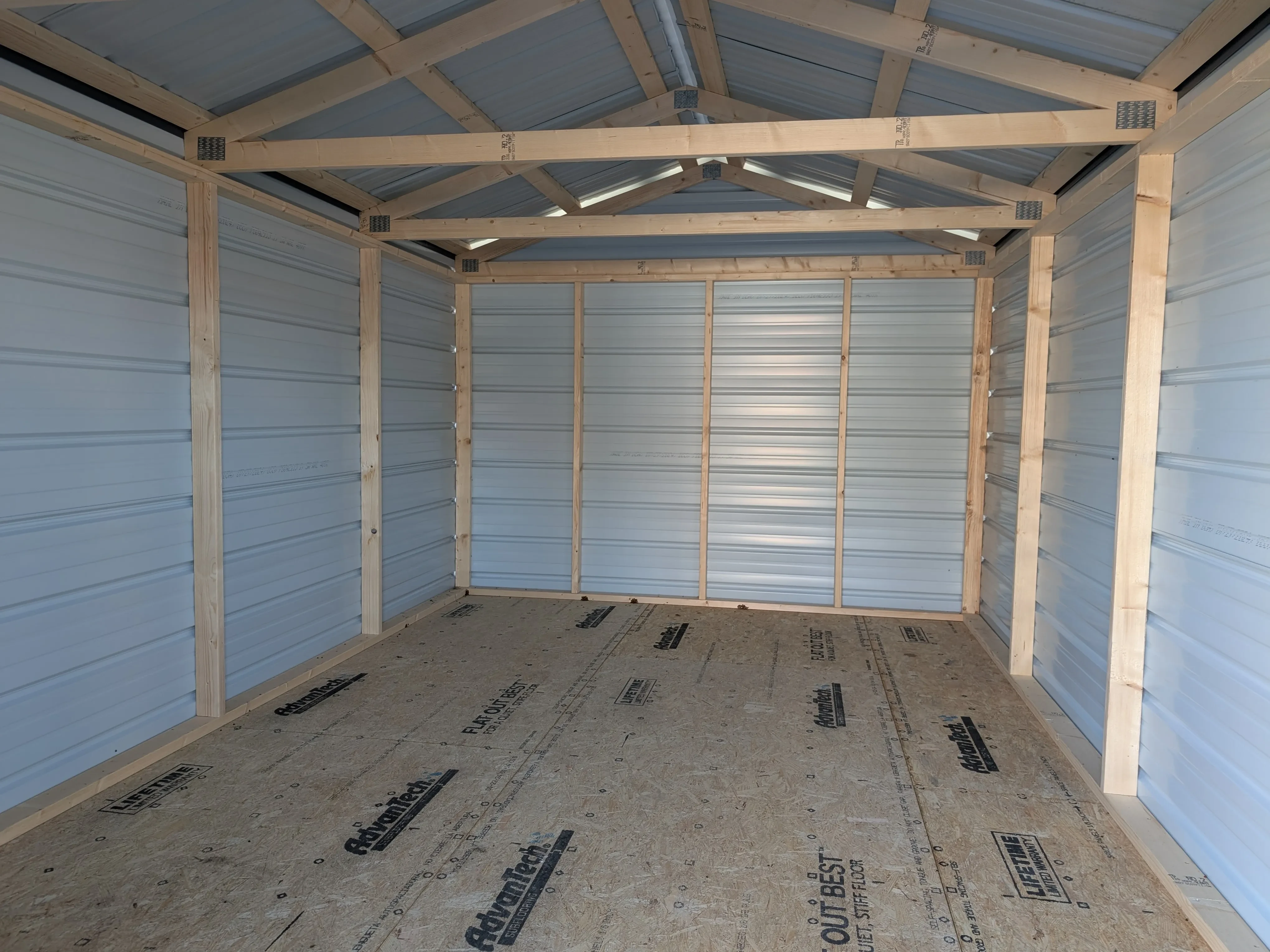 inside a metal utility shed. You can see the floor is solid and the lumber framing