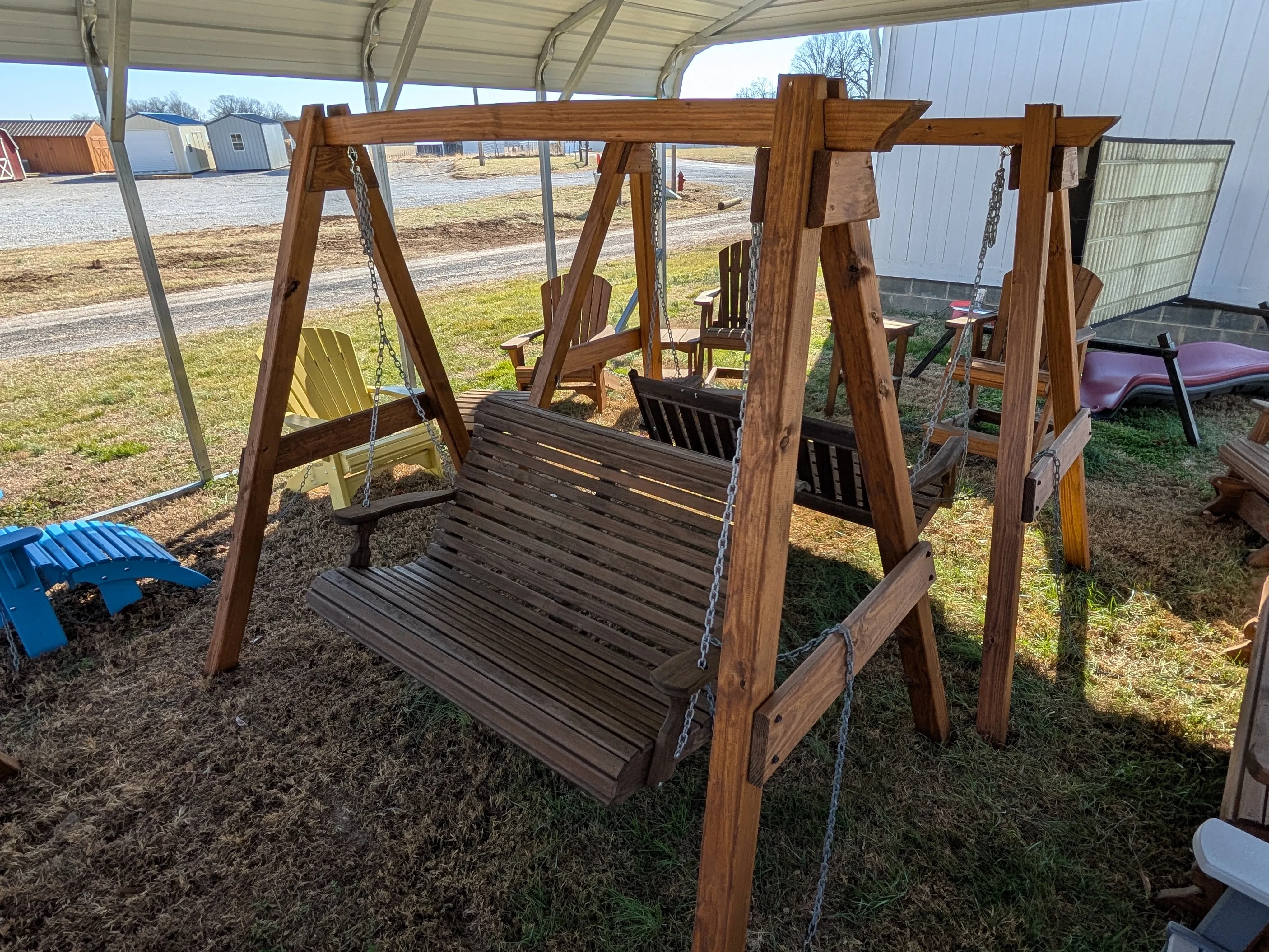 a wooden a-frame structure holding up a wooden bench, it's near other furniture