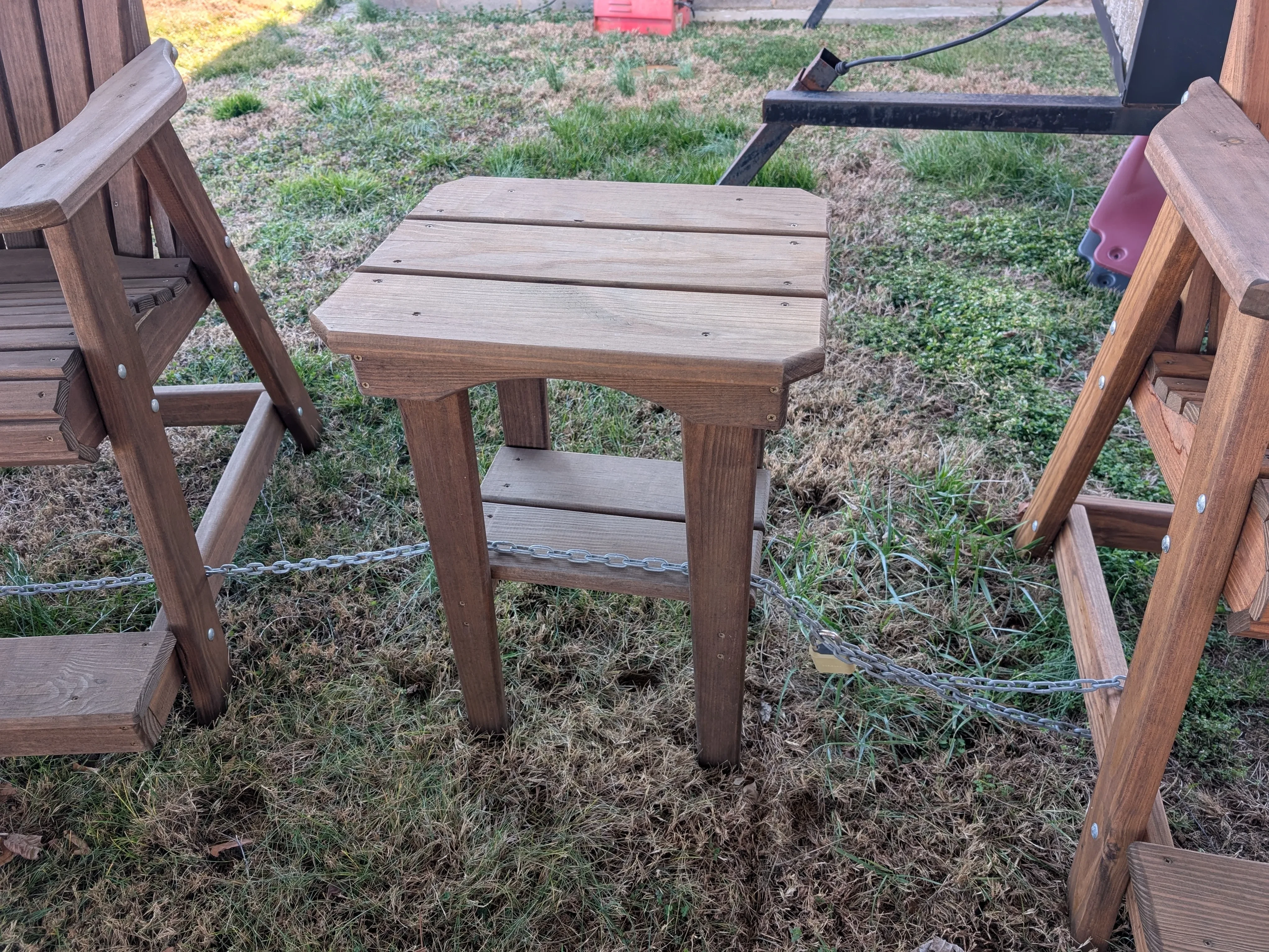 a small table chain up to other furniture. It is stained and sealed brown