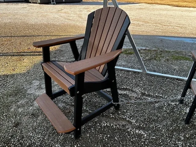 a polywood chair with foot and arm rests. It is chained up to other furniture
