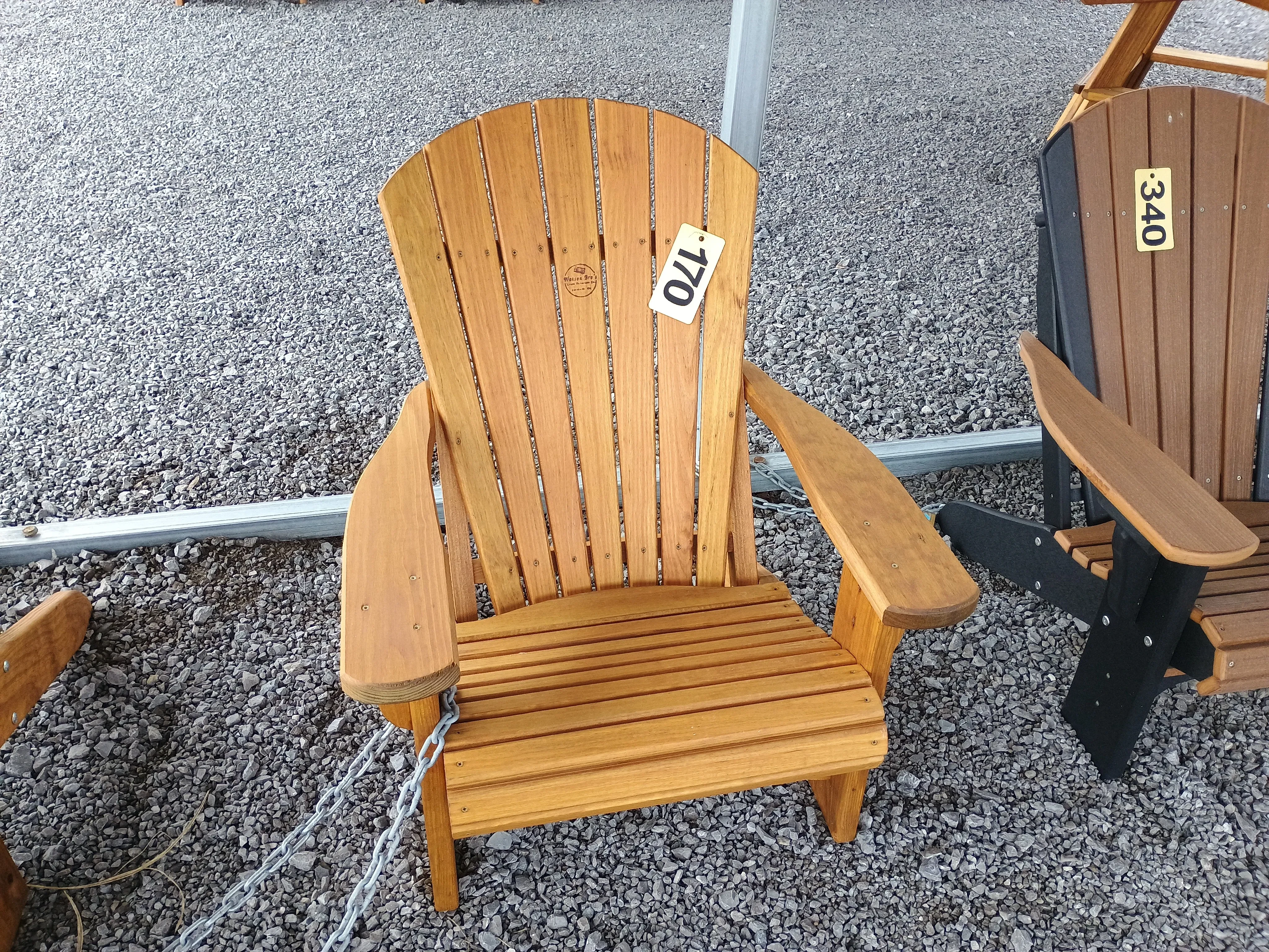 two light wood stained chairs with a table in between them. There are price tags on each item