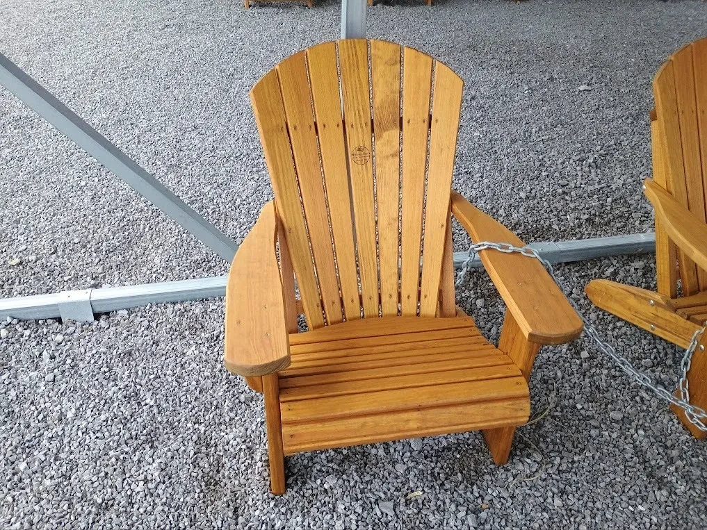 a wood chair sitting in the gravel. It is professionally stained and sealed