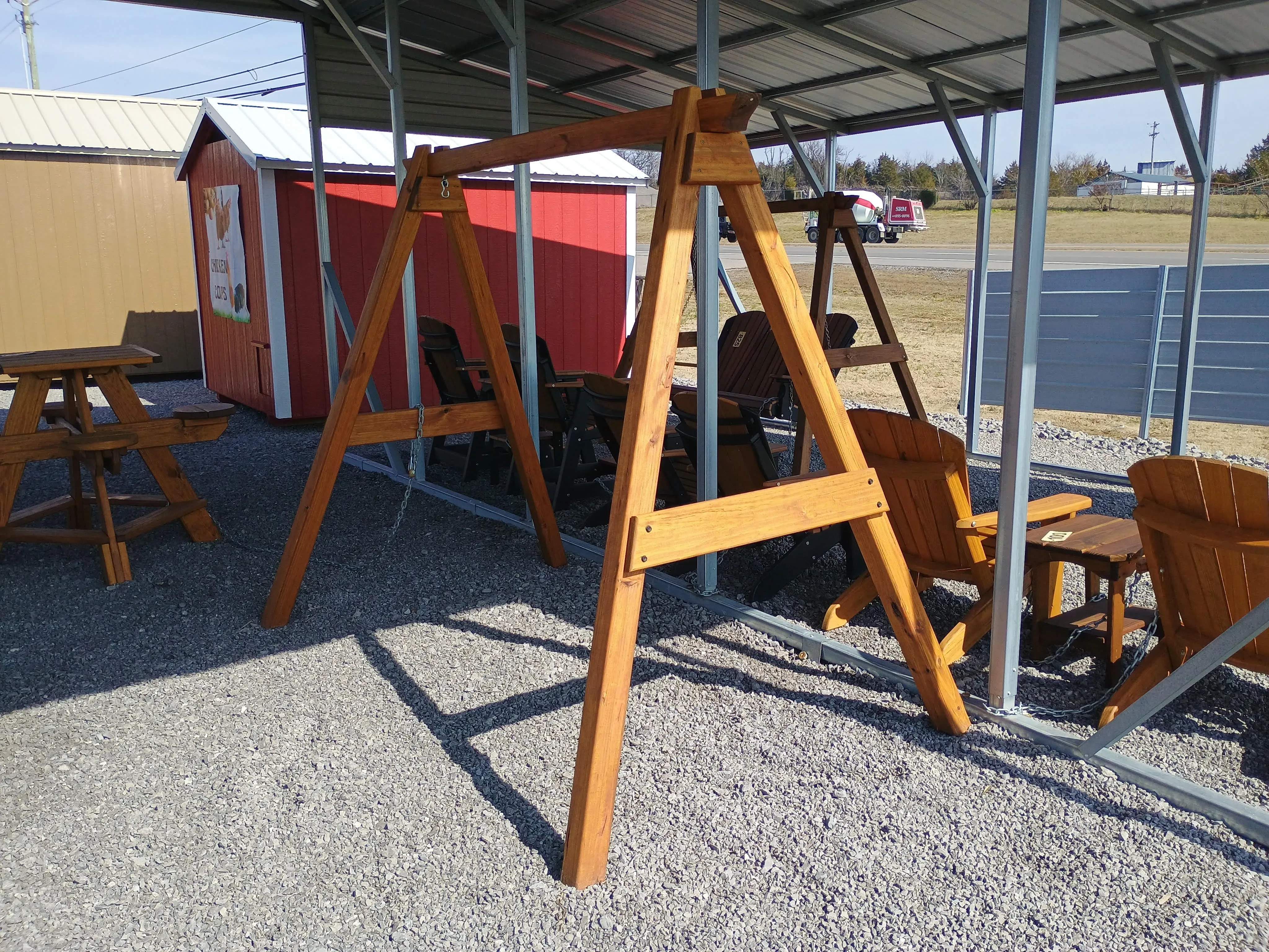 the side view of an a-frame wooden structure. It is meant to hold up a bench or swing