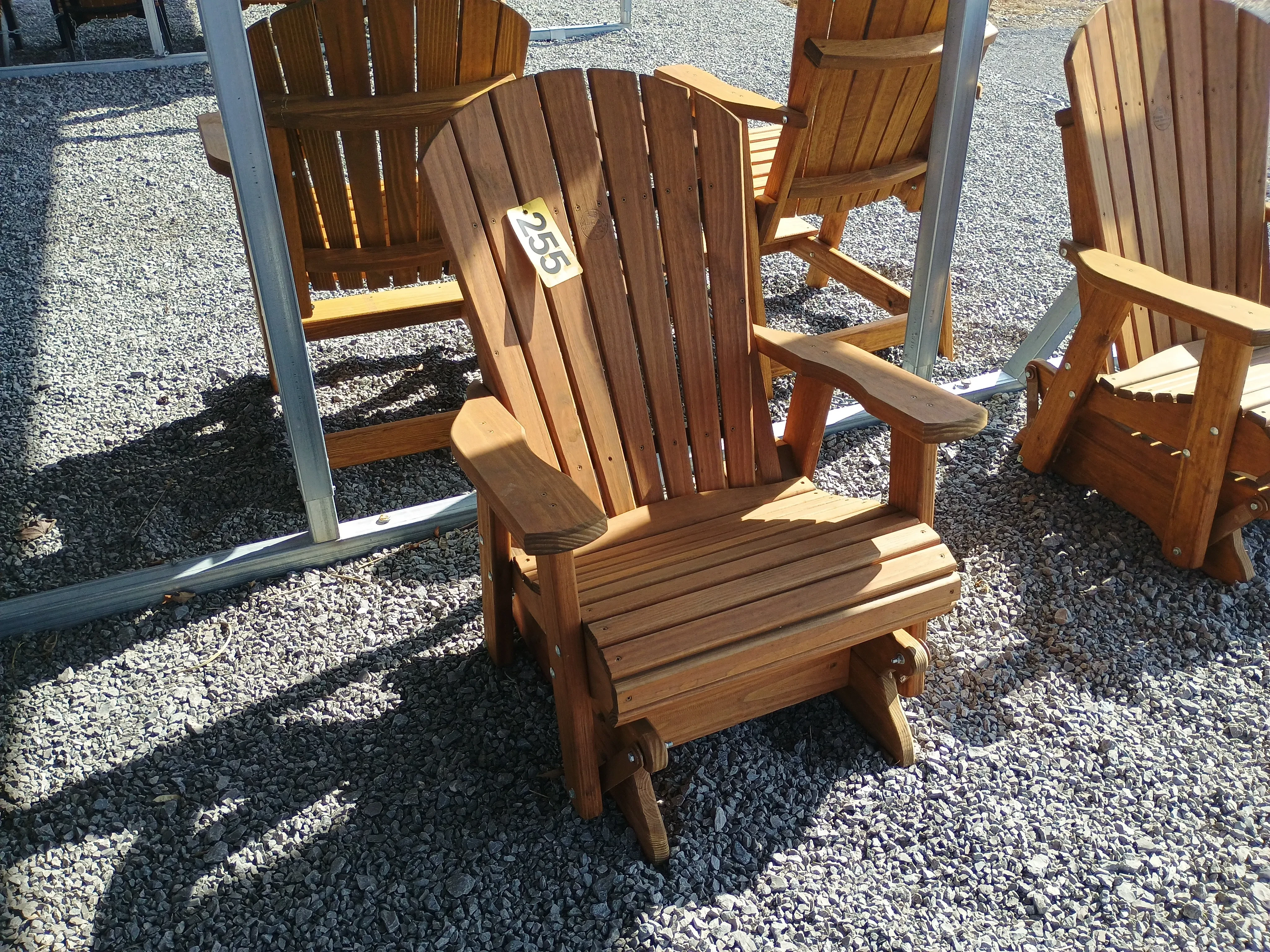 a chair sitting in the gravel. It is professionally stained and sealed and can glide back and forth