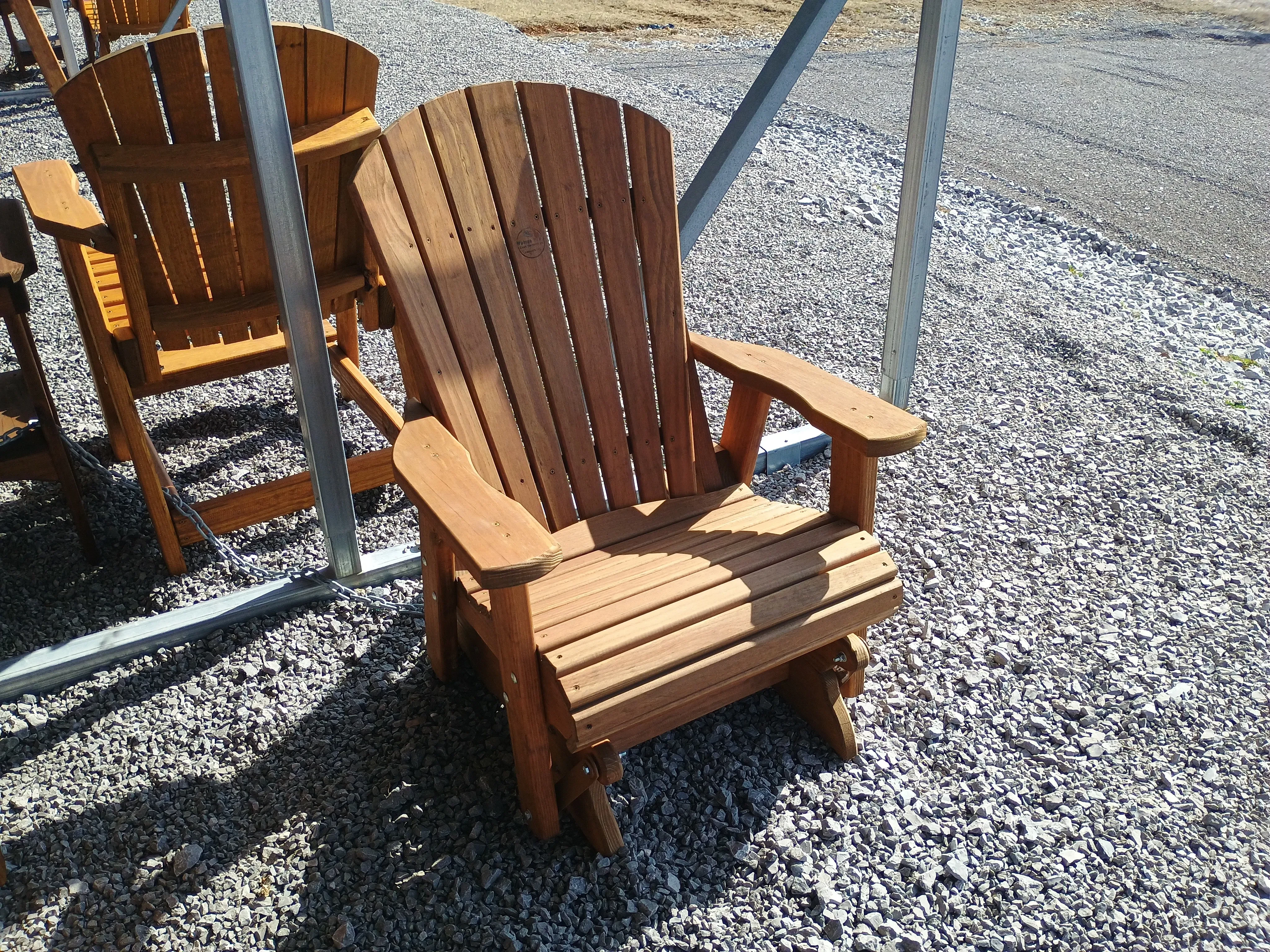 a chair sitting in the gravel under a carport. It is professionally stained and sealed to last a very long time