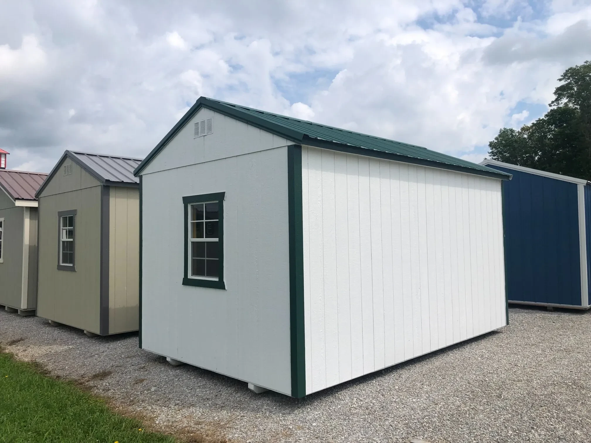 The rear corner view of a wood shed showing a window in the back wall