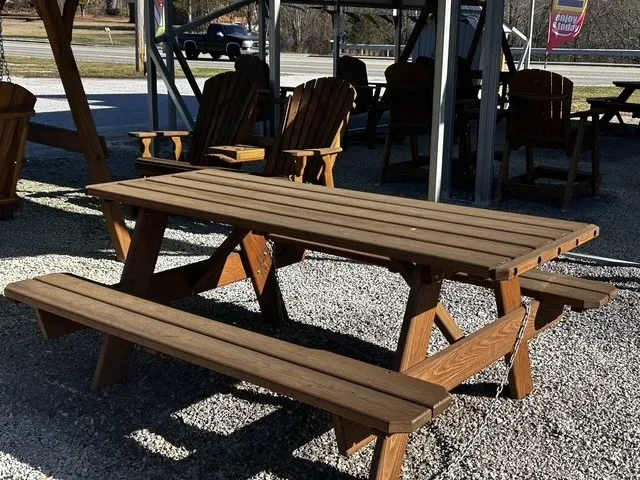 a picnic bench sitting in the gravel. it is professionally stained and sealed to last a long time