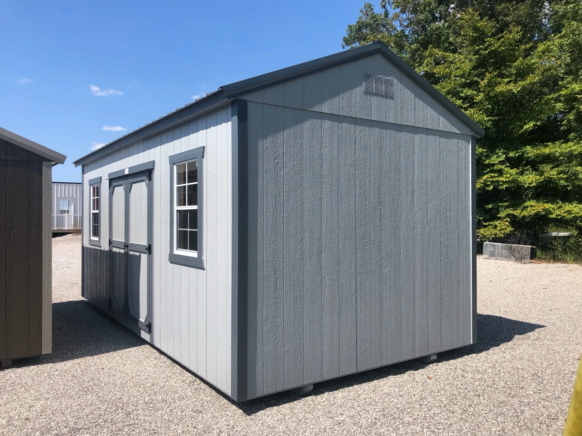 the side view of a garden shed with 2 windows