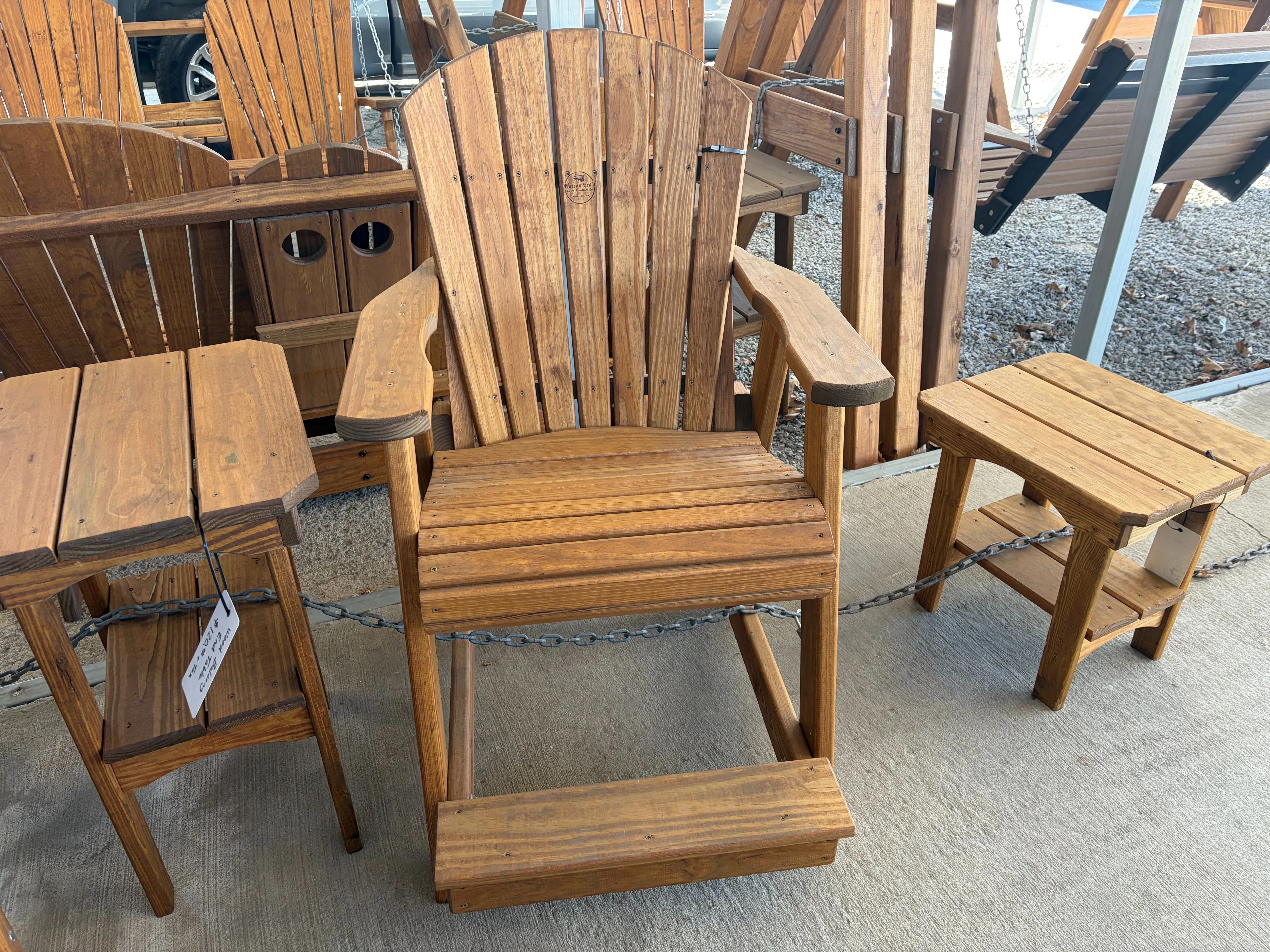 a professionally stained and sealed wood chair. It is chained up with other furniture that is nearby