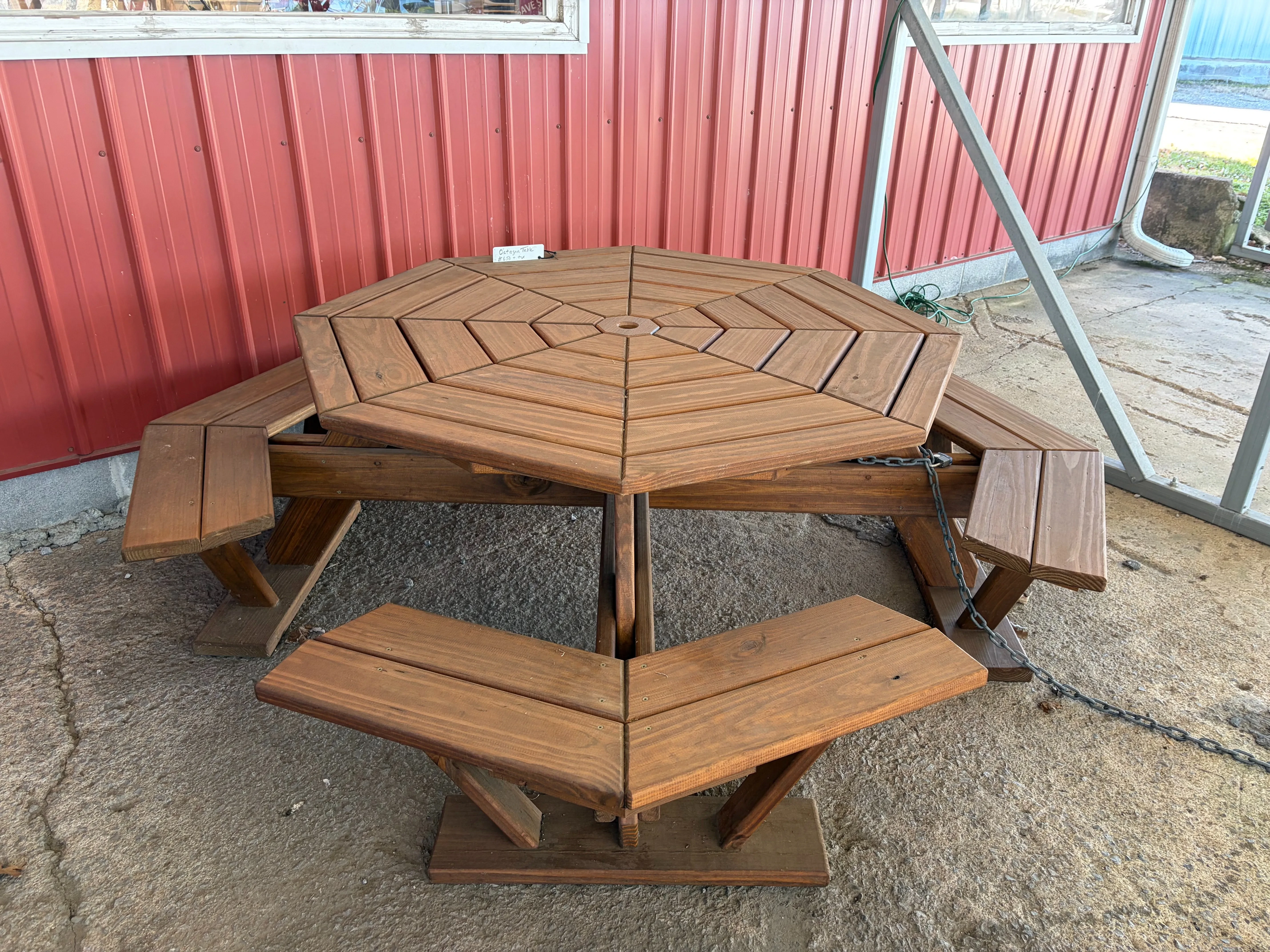 a table cut and built to form an octagon. It is professionally stained and sealed to last a very long time. It is chained up