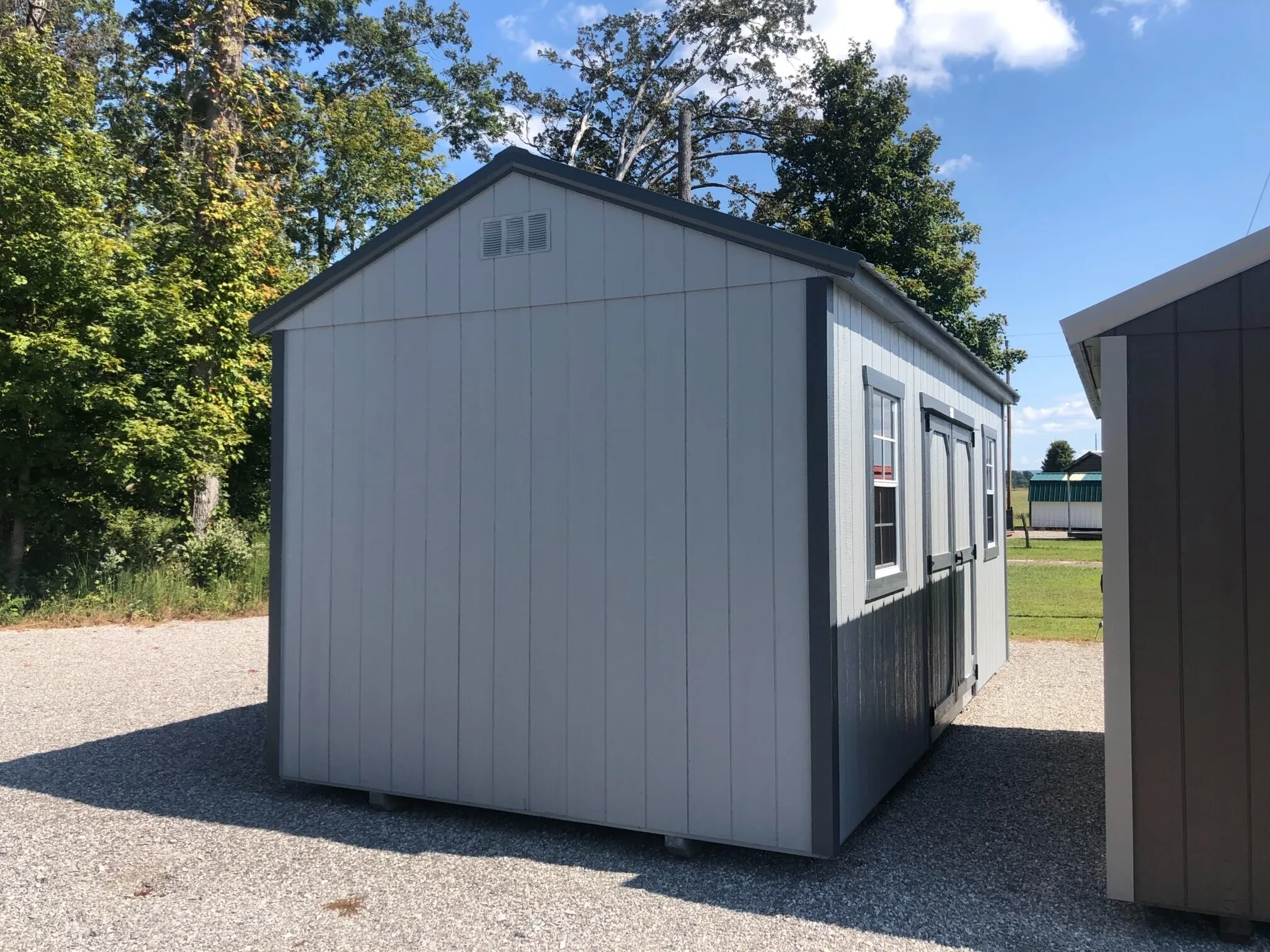 the side view of a garden shed showing 2 windows and a vent