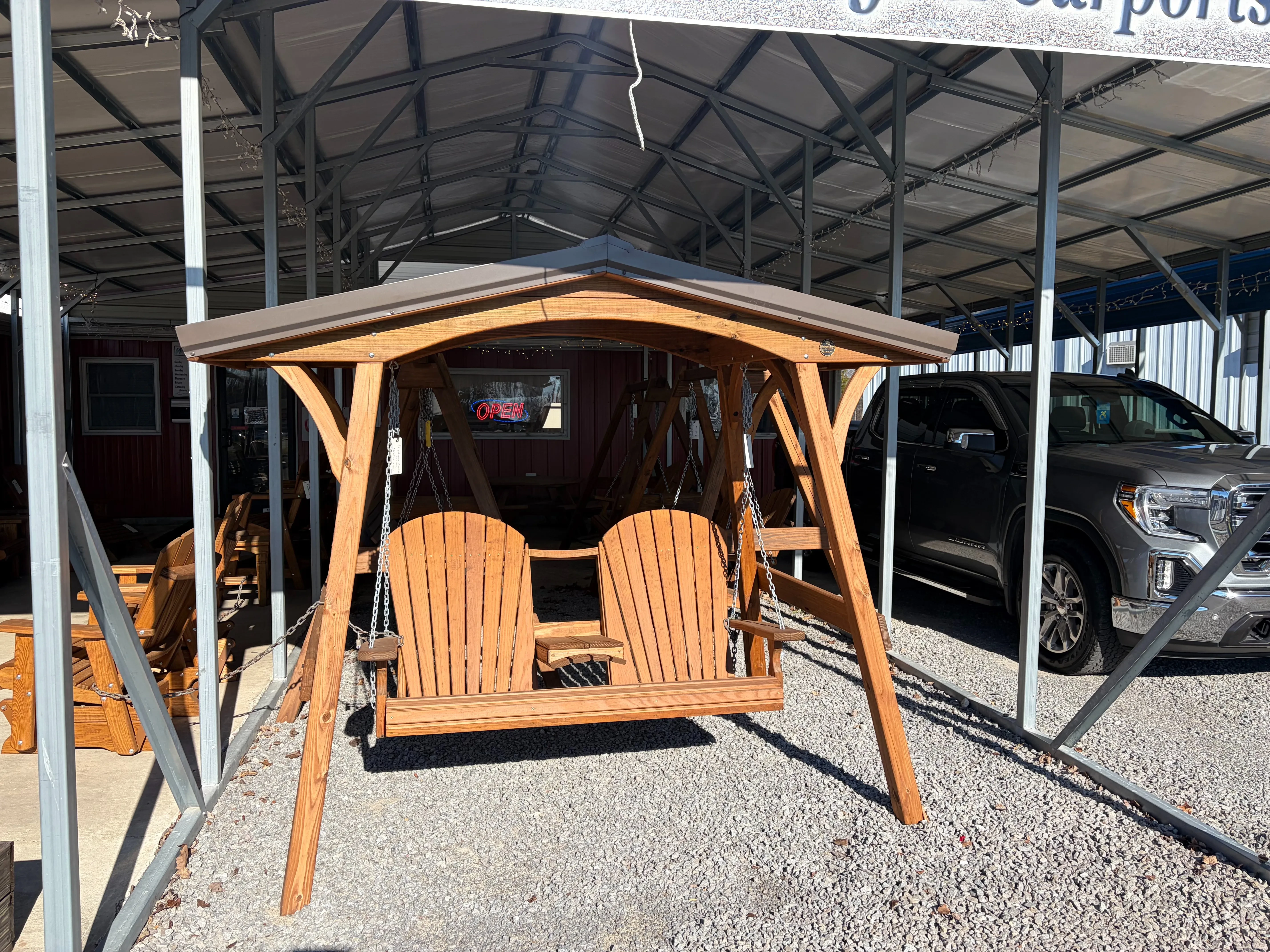 a swing cover structure holding up a wood stained and sealed bench that seats two. It has a center console which is down.